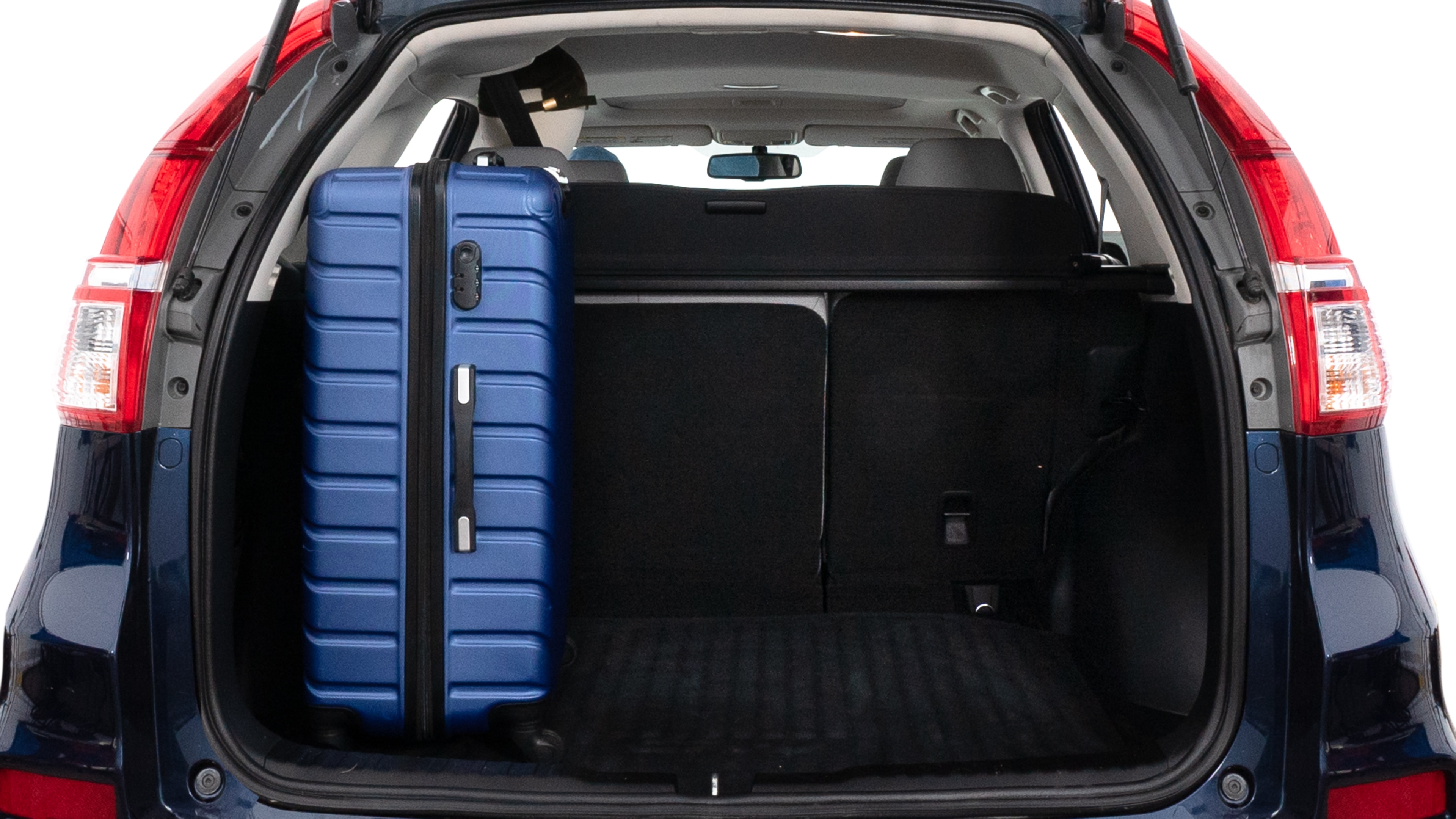 The trunk lid is open, showing full view of the trunk space. One large, two medium and two small suitcases are placed inside.