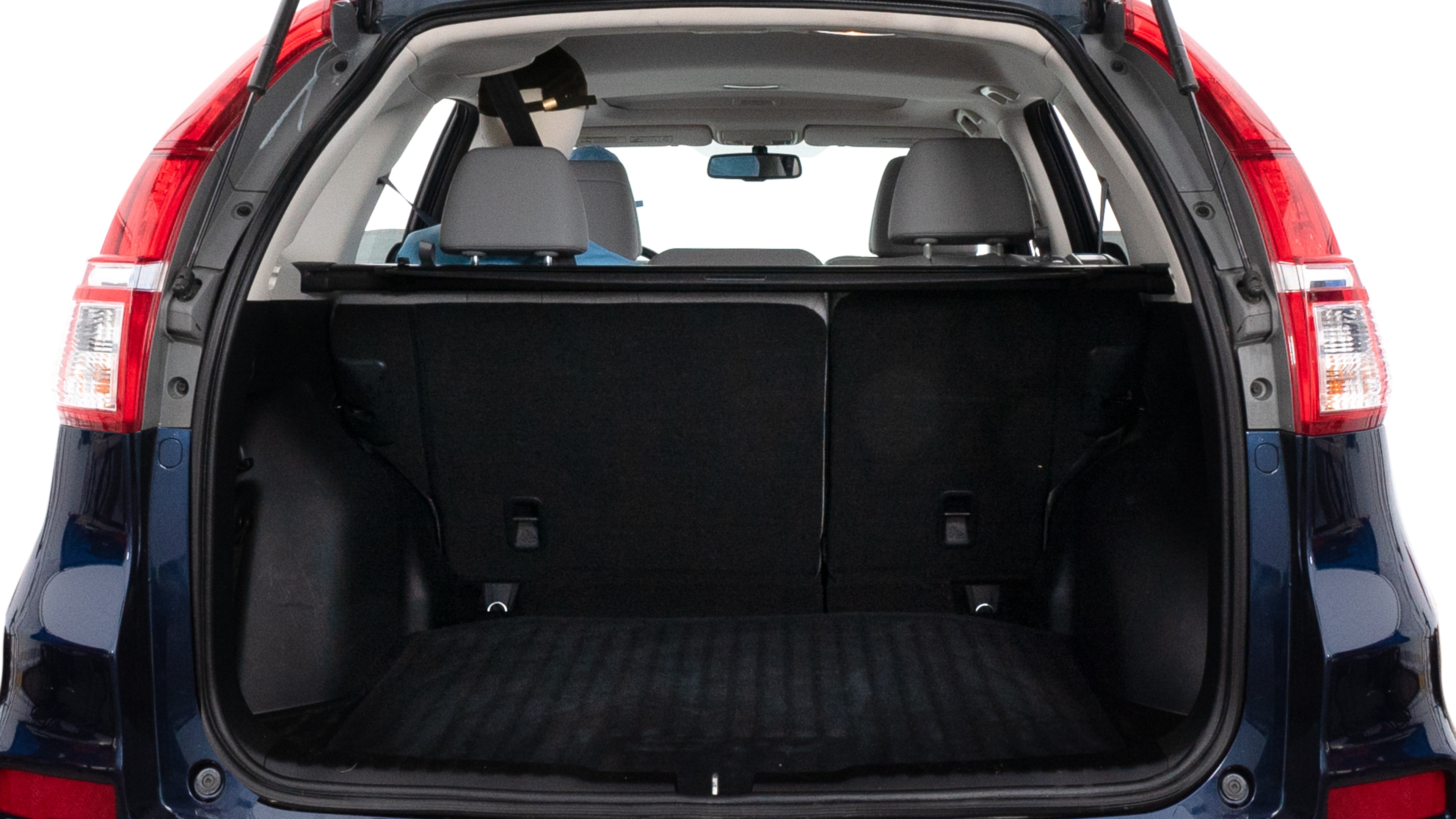 The trunk lid is open, showing full view of the trunk space. One large, two medium and two small suitcases are placed inside.