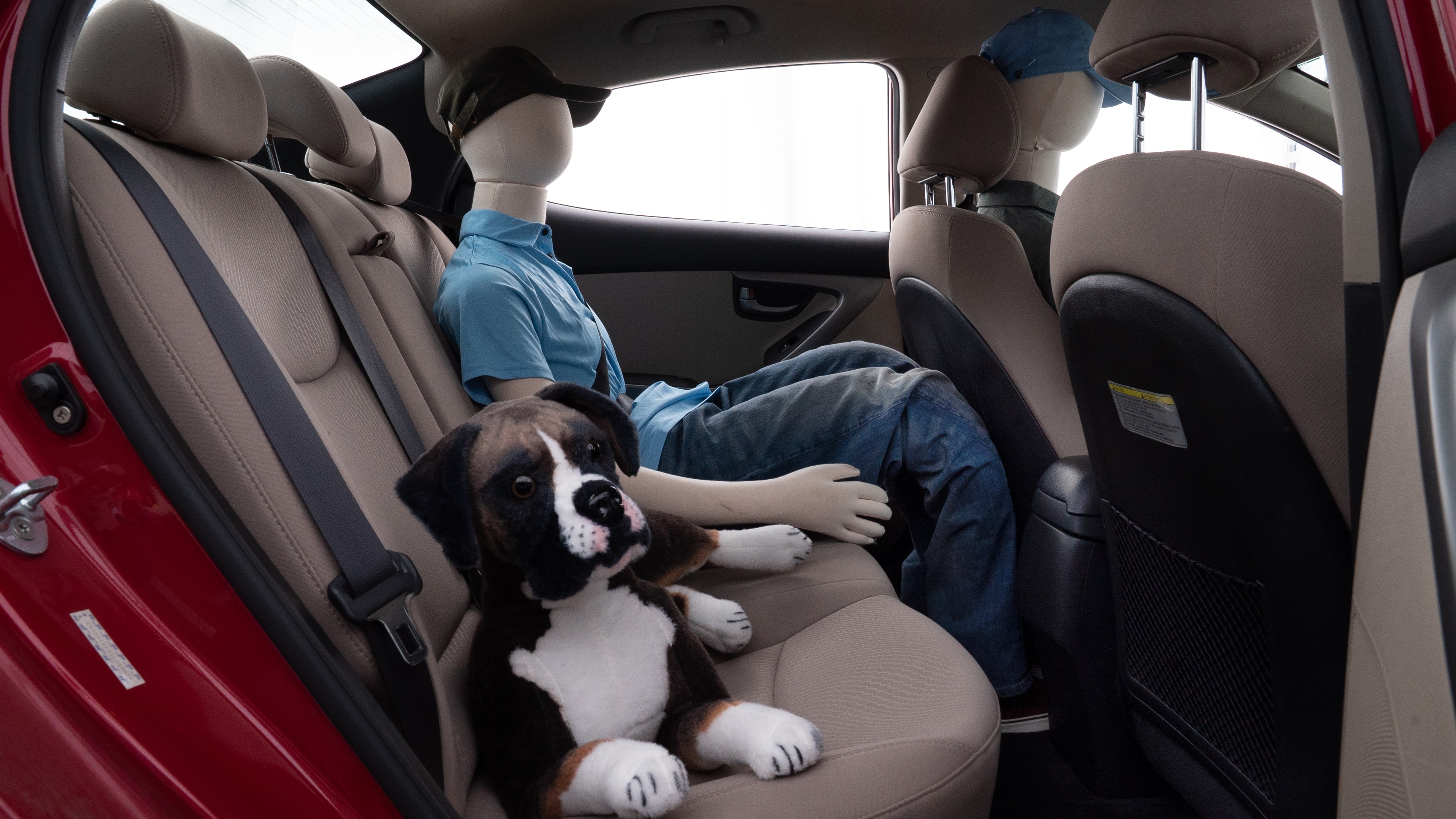 A series of second-row backseat photos is shown including one seating a baby seat and one seating a 6'1" mannequin.