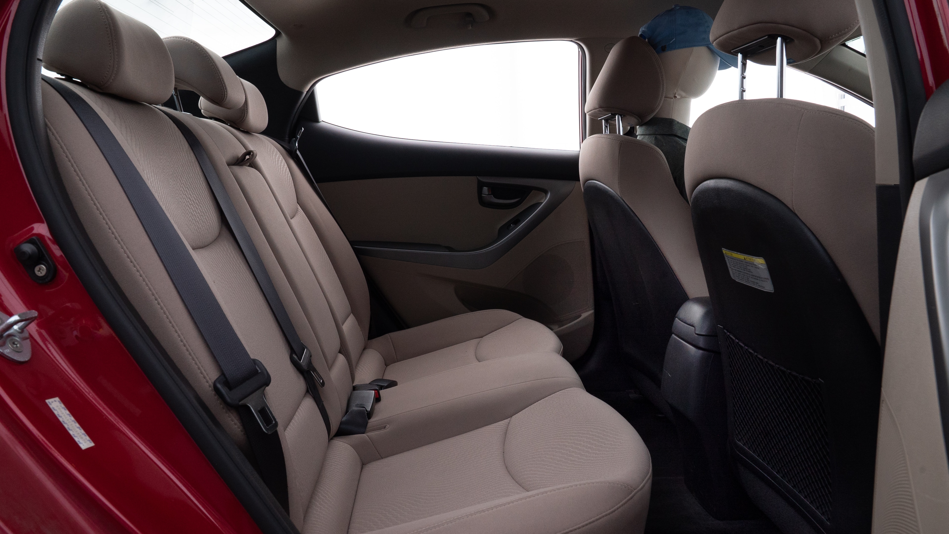 A series of second-row backseat photos is shown including one seating a baby seat and one seating a 6'1" mannequin.