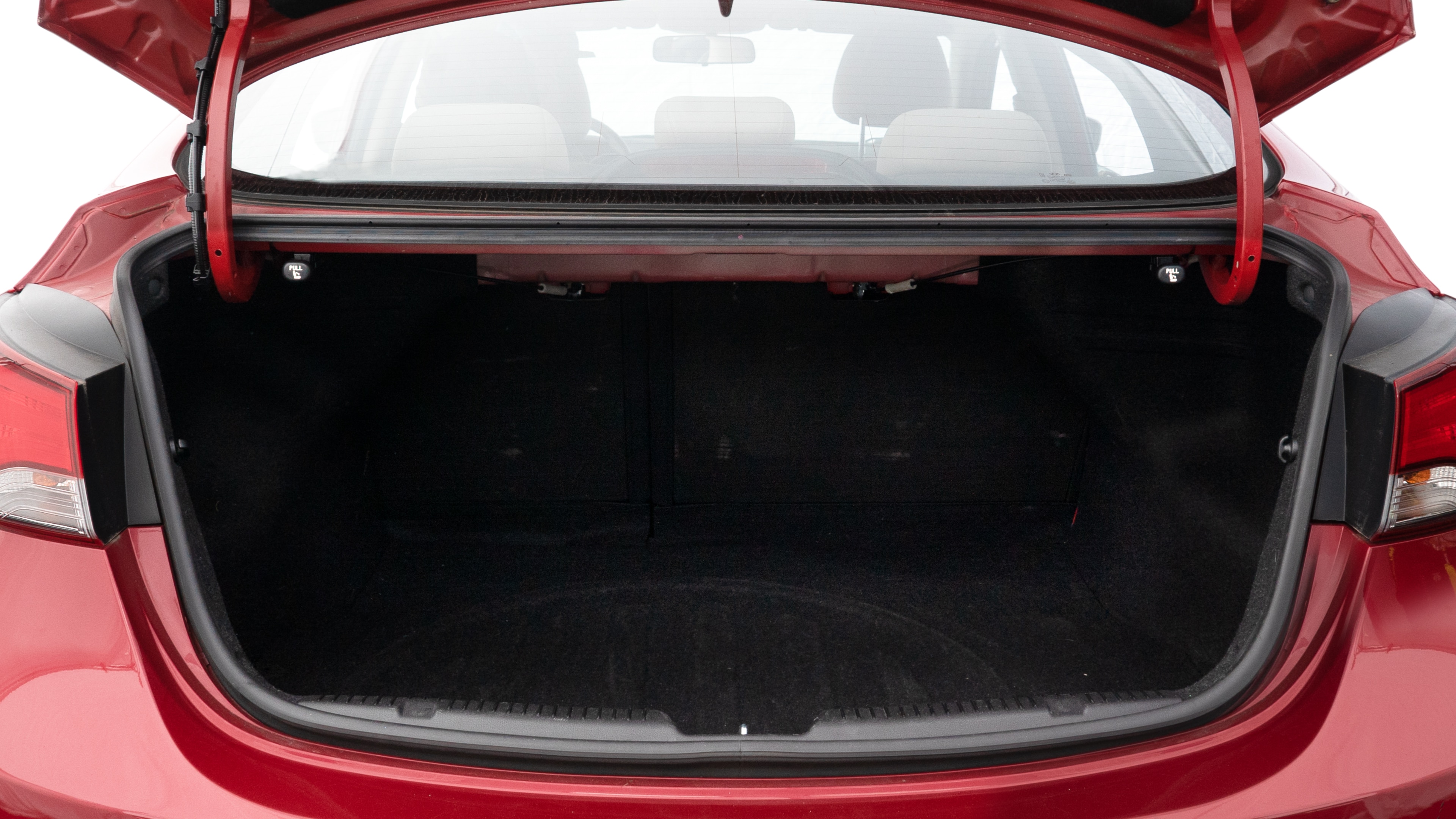 The trunk lid is open showing full view of the trunk. A baby stroller, three grocery carriers, two camping chairs in the carrying bag, and a set of golf clubs are placed inside.