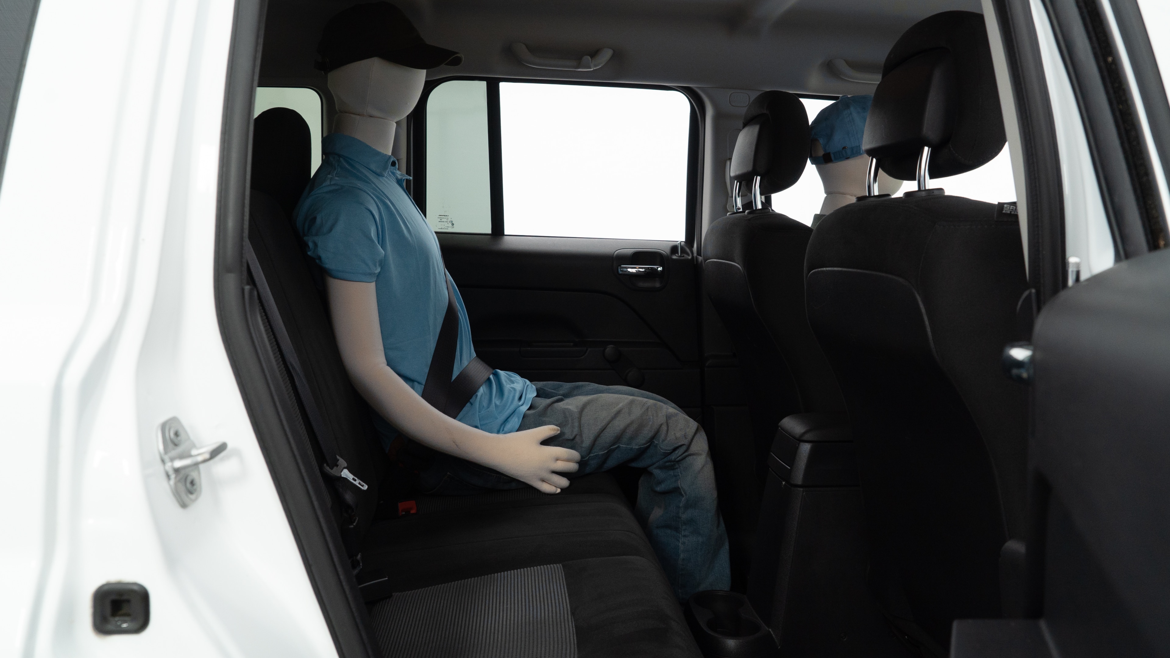 A series of second-row backseat photos is shown including one seating a baby seat and one seating a 6'1" mannequin.