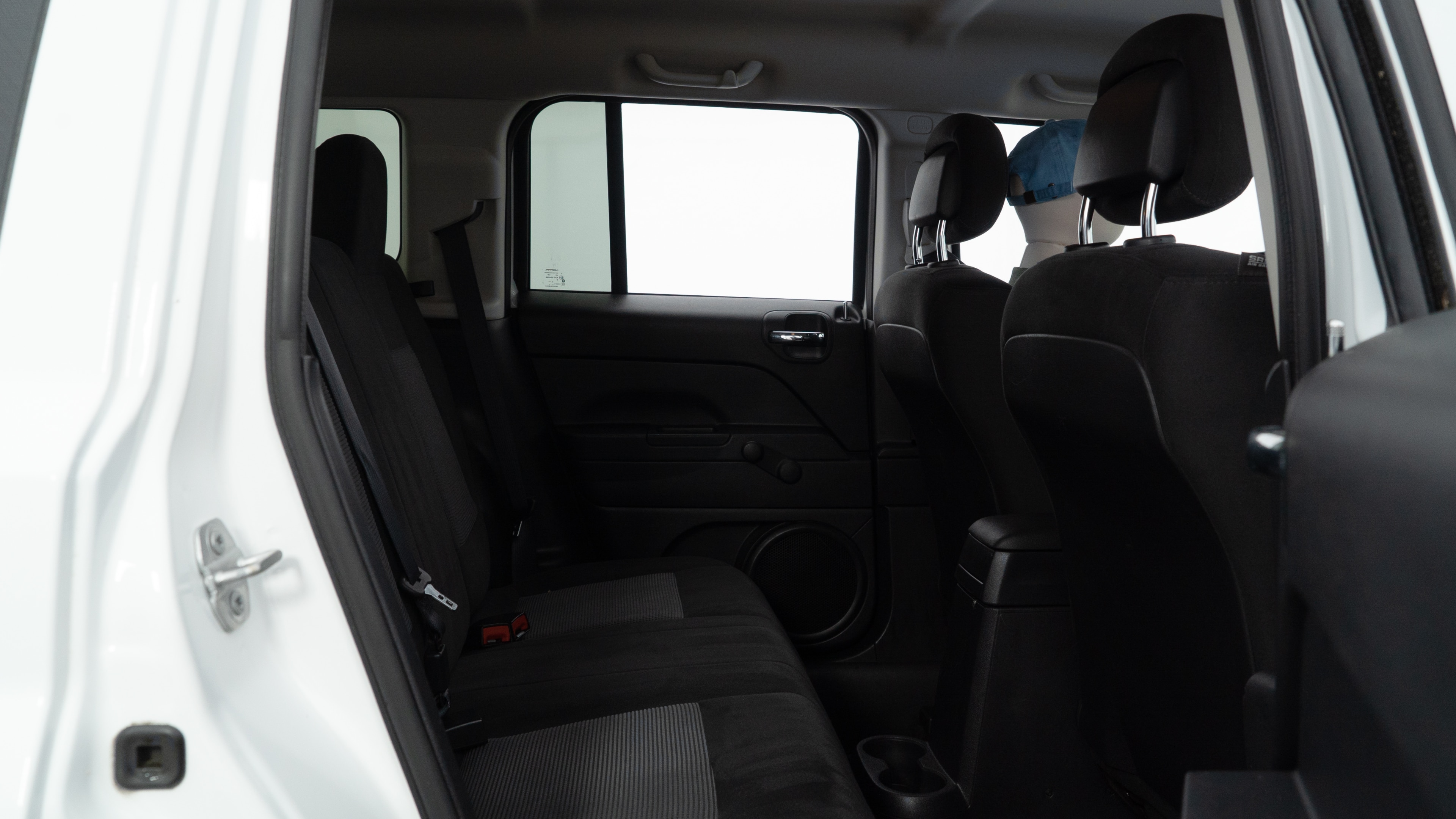 A series of second-row backseat photos is shown including one seating a baby seat and one seating a 6'1" mannequin.