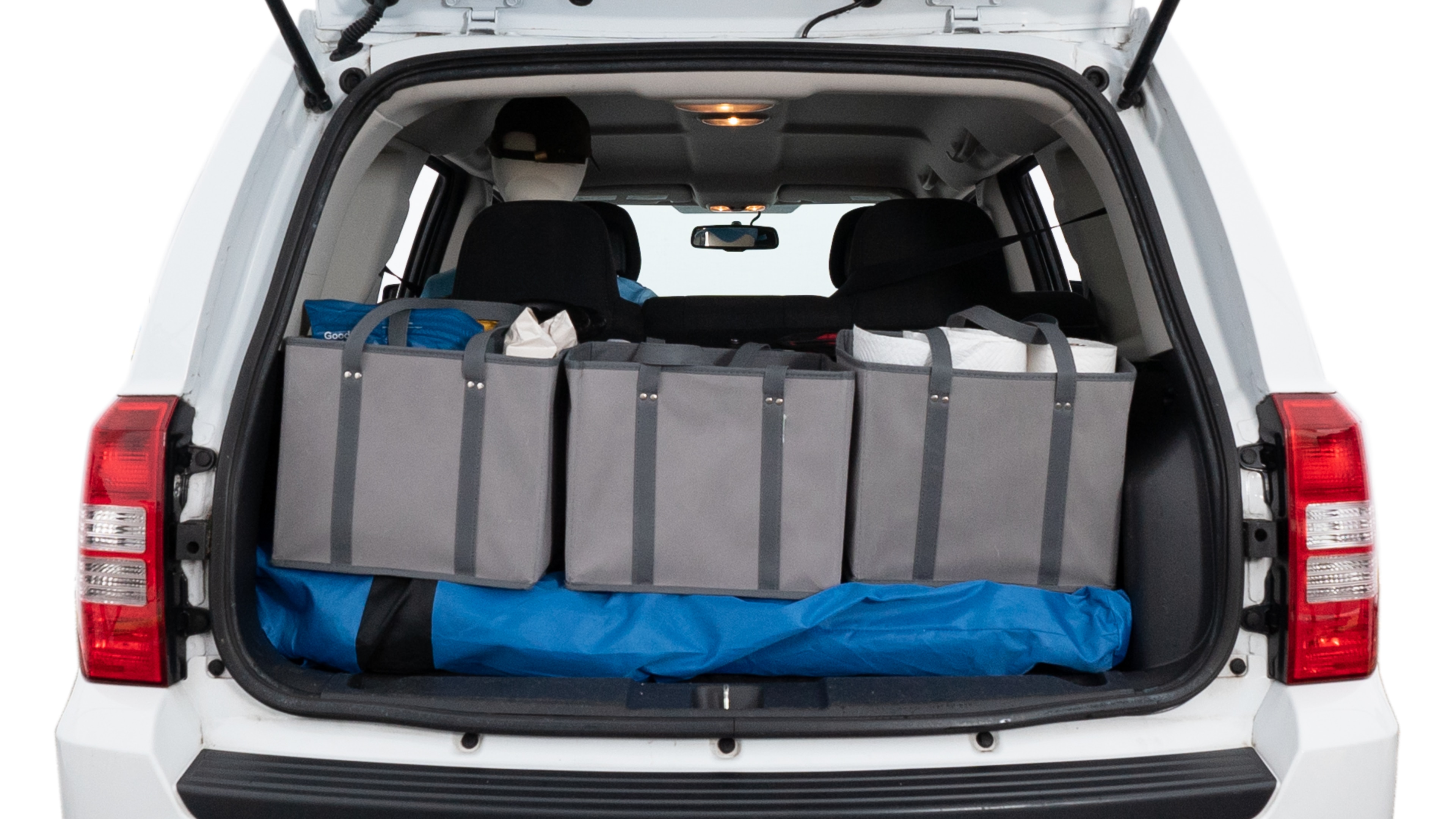 The trunk lid is open showing full view of the trunk. A baby stroller, three grocery carriers, two camping chairs in the carrying bag, and a set of golf clubs are placed inside.