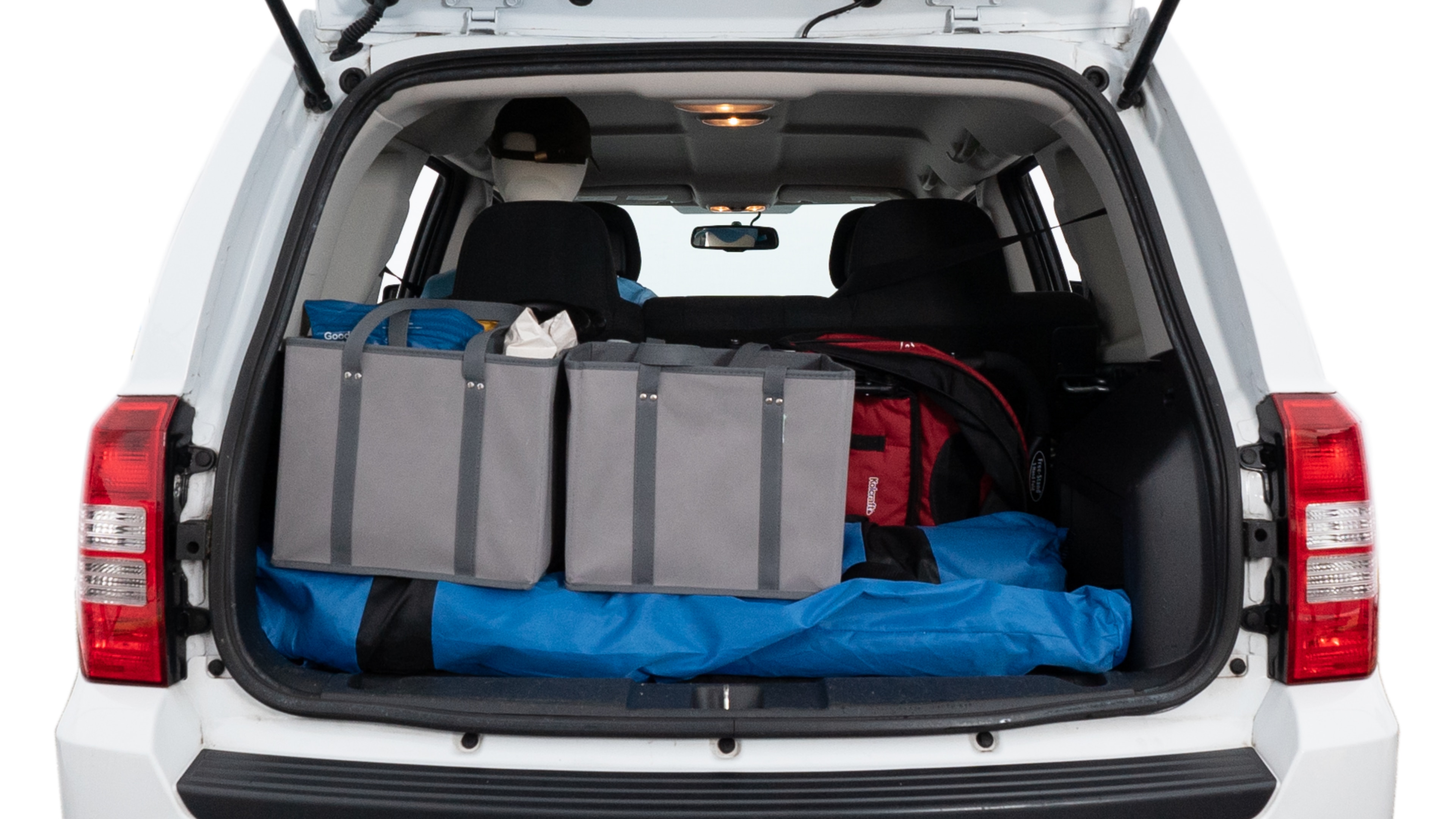 The trunk lid is open showing full view of the trunk. A baby stroller, three grocery carriers, two camping chairs in the carrying bag, and a set of golf clubs are placed inside.