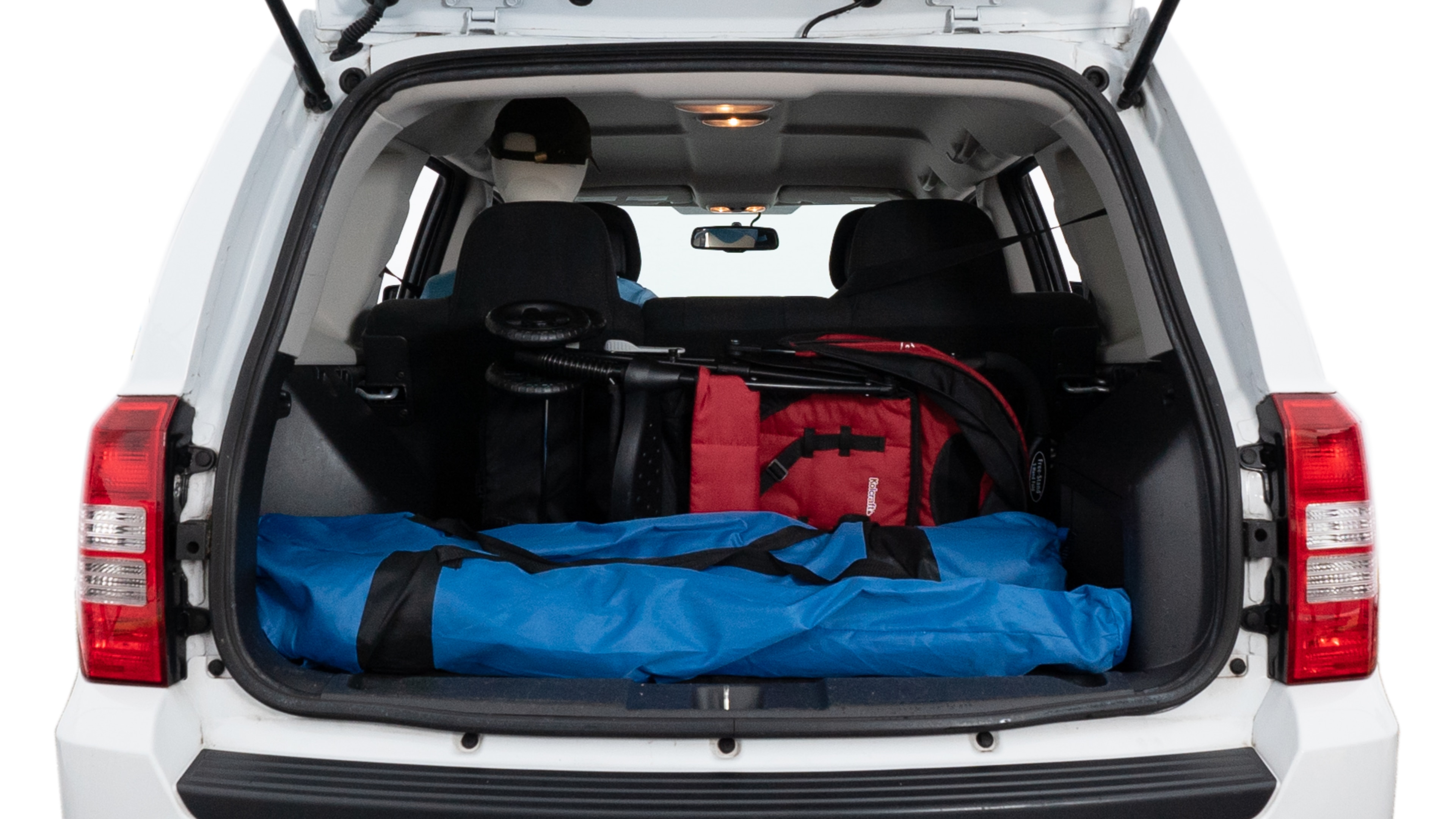 The trunk lid is open showing full view of the trunk. A baby stroller, three grocery carriers, two camping chairs in the carrying bag, and a set of golf clubs are placed inside.