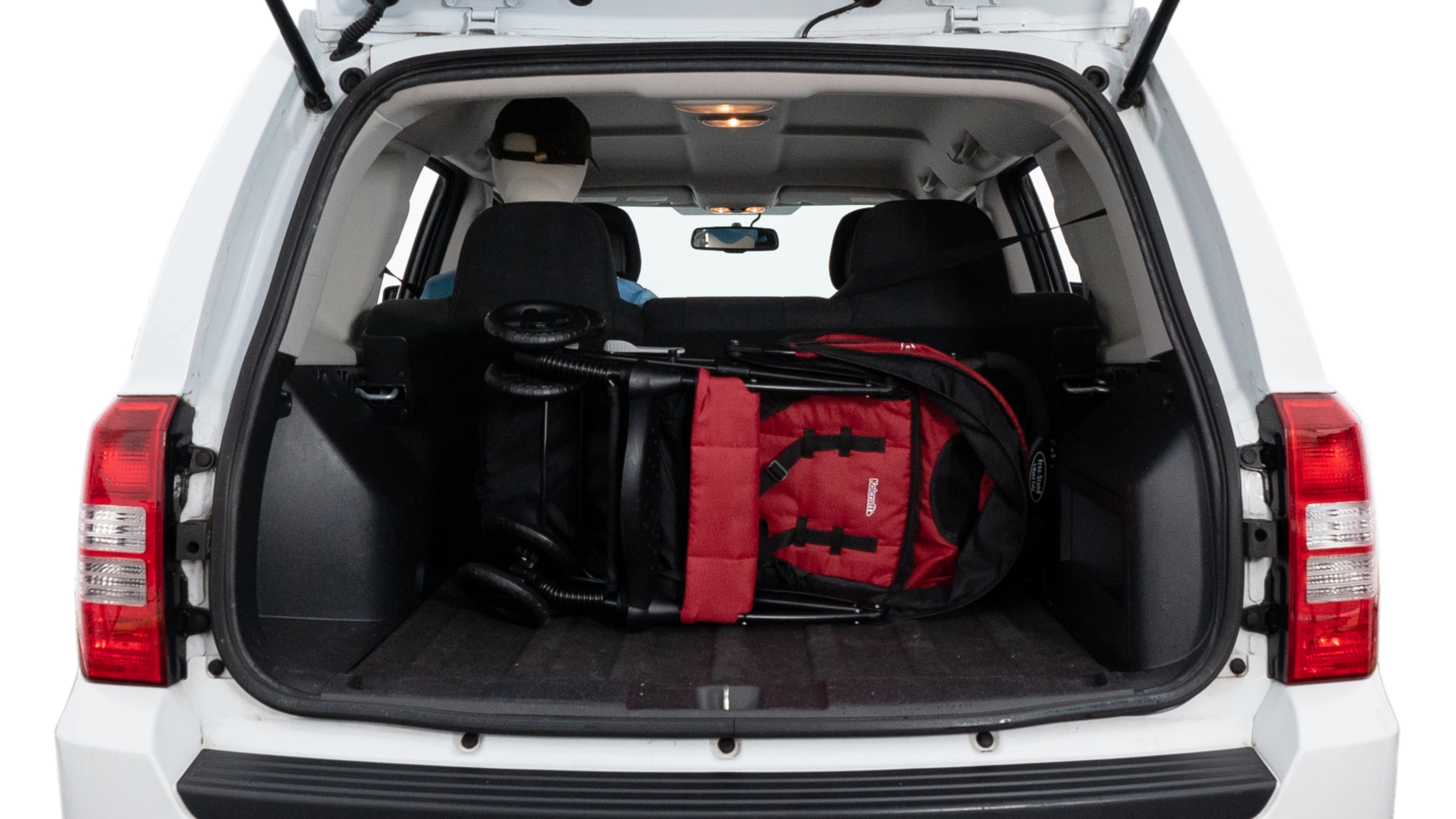 The trunk lid is open showing full view of the trunk. A baby stroller, three grocery carriers, two camping chairs in the carrying bag, and a set of golf clubs are placed inside.