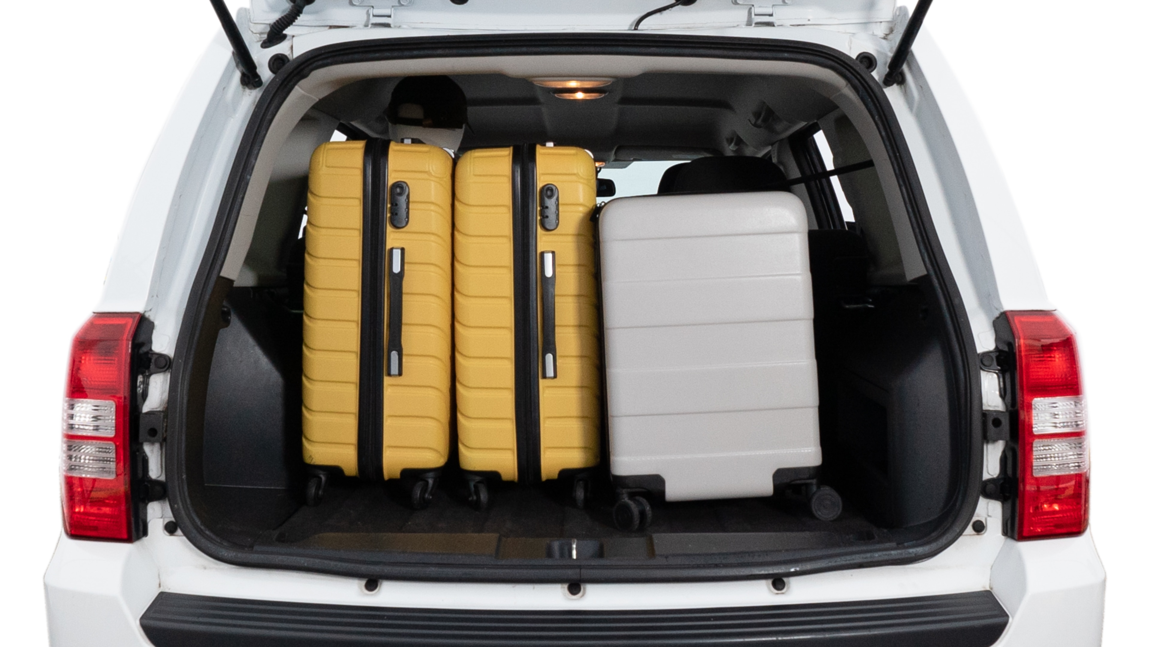The trunk lid is open, showing full view of the trunk space. Two medium and two small suitcases are placed inside.