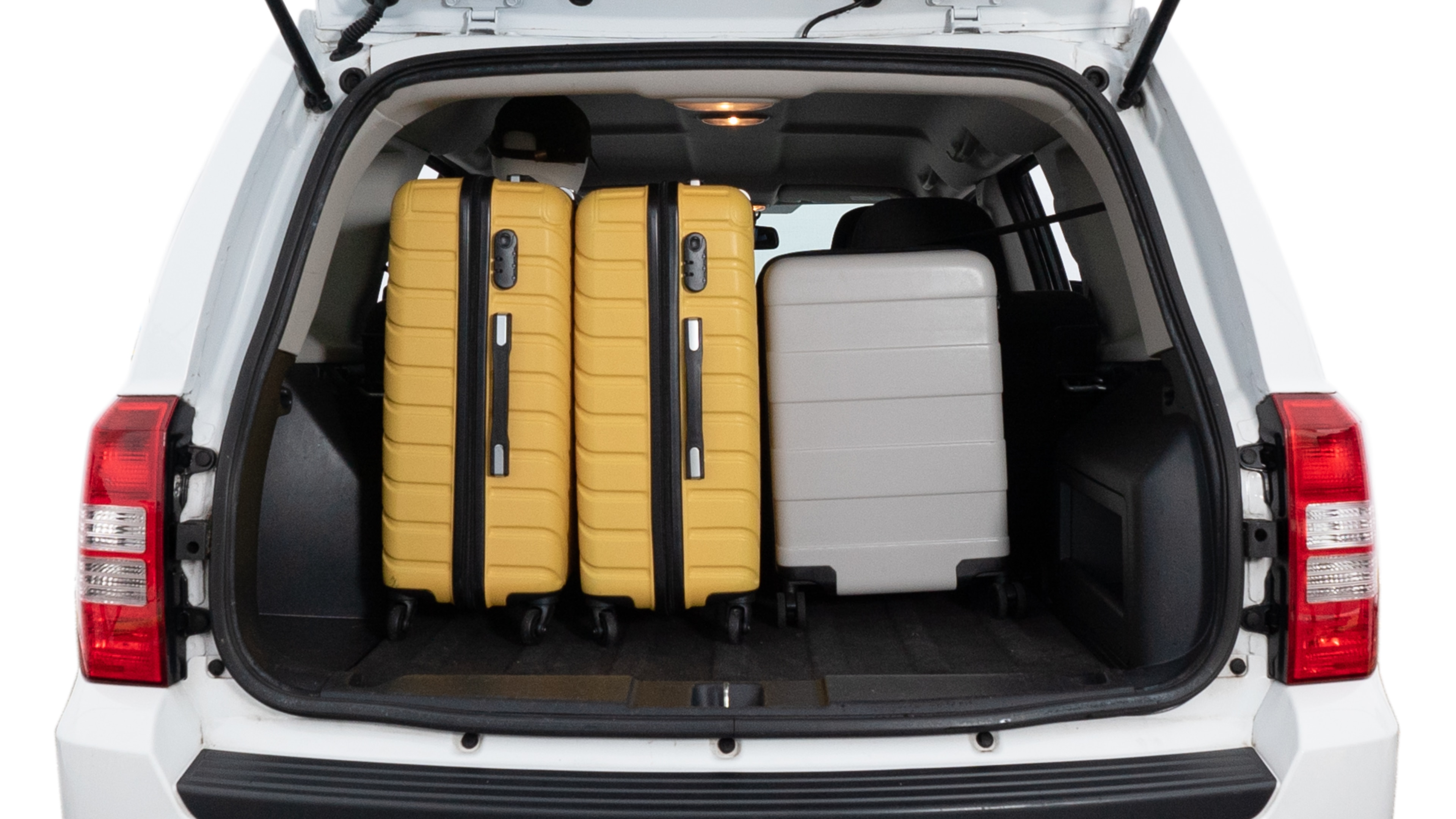 The trunk lid is open, showing full view of the trunk space. Two medium and two small suitcases are placed inside.