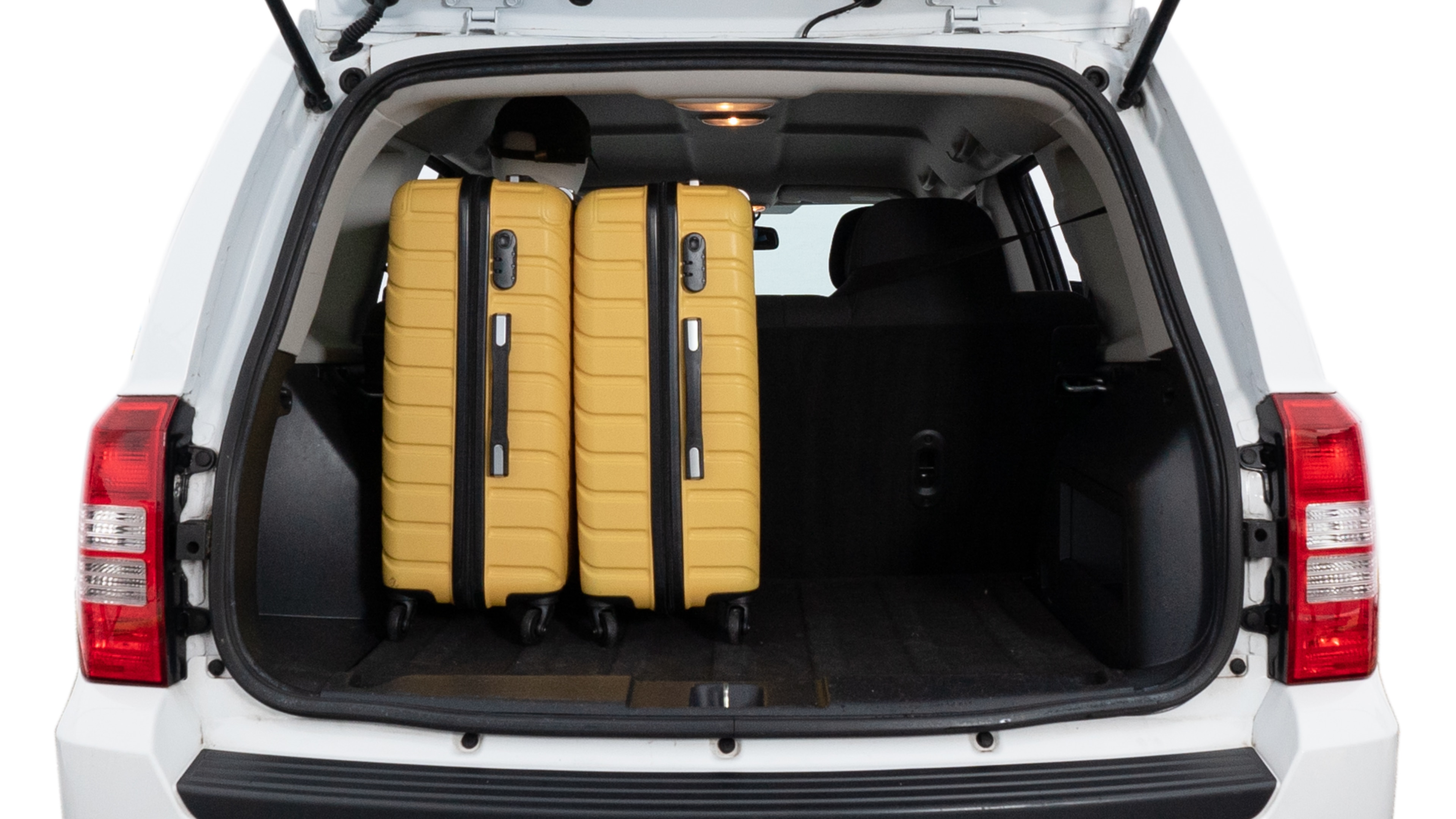 The trunk lid is open, showing full view of the trunk space. Two medium and two small suitcases are placed inside.