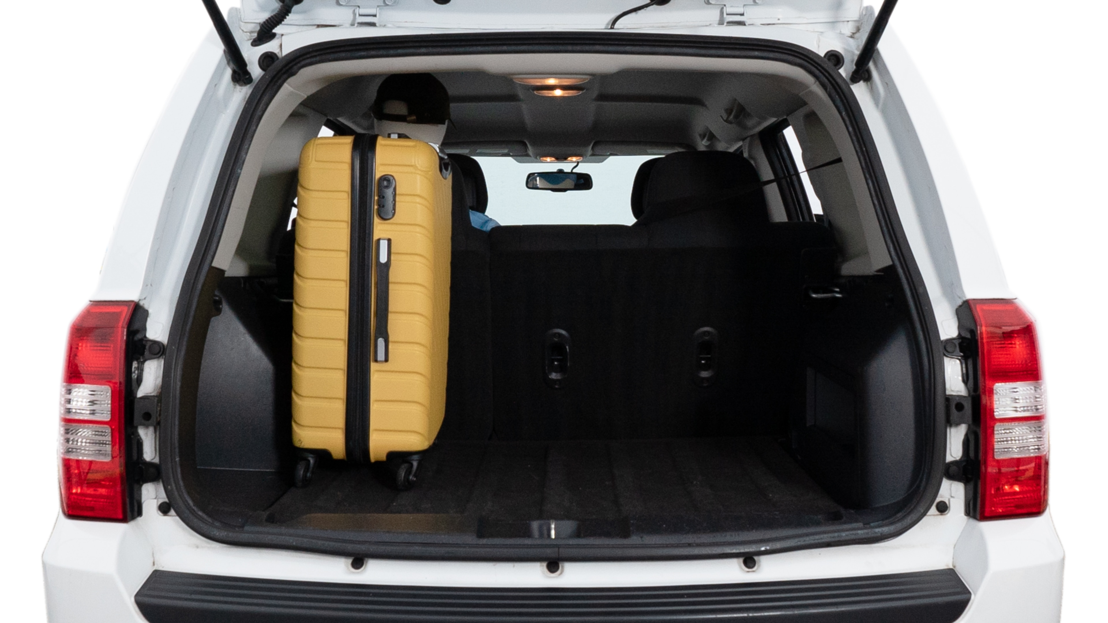 The trunk lid is open, showing full view of the trunk space. Two medium and two small suitcases are placed inside.
