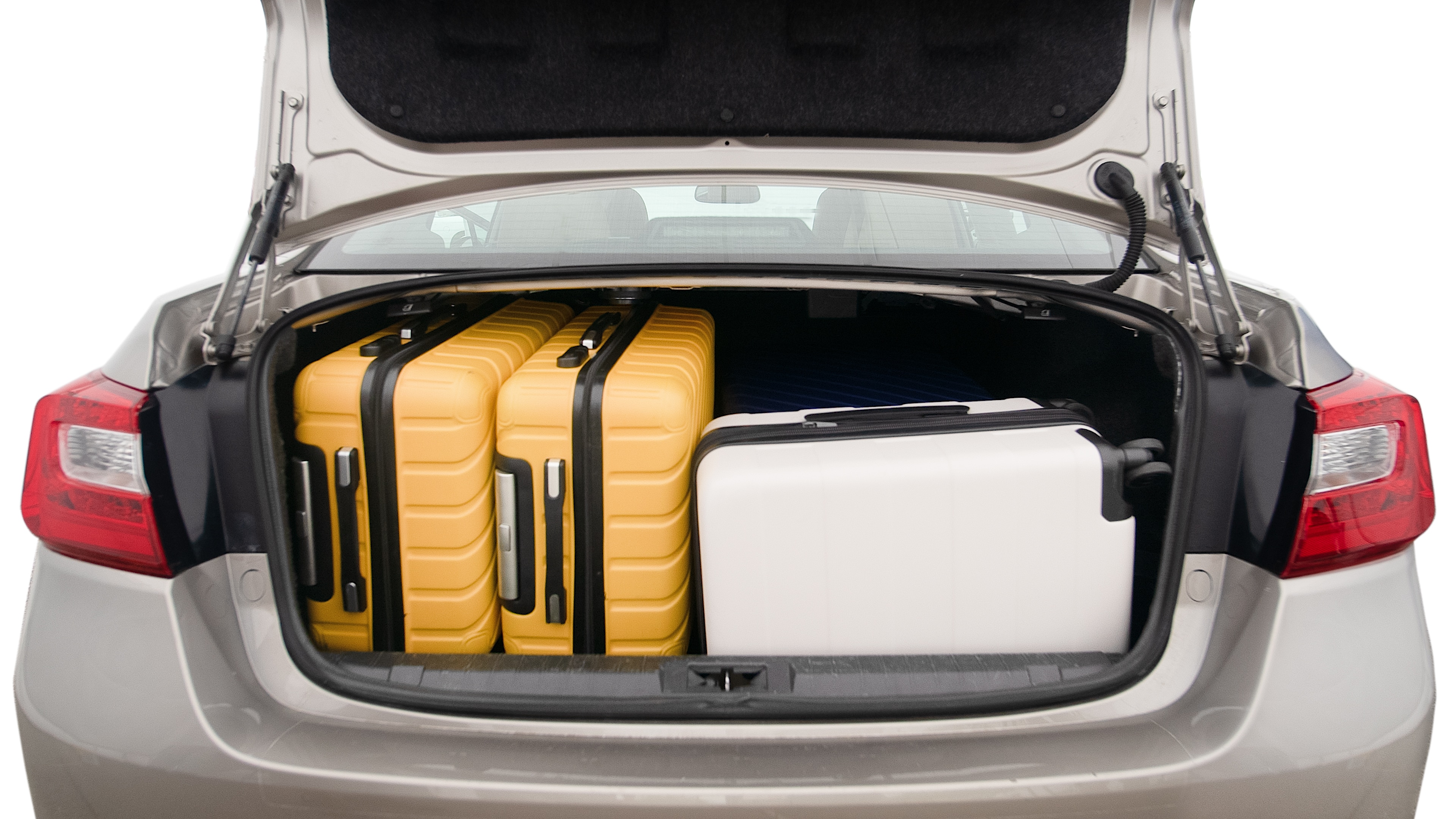 The trunk lid is open, showing full view of the trunk space. One extra large suitcase, two large suitcases and one small suitcase are placed inside.