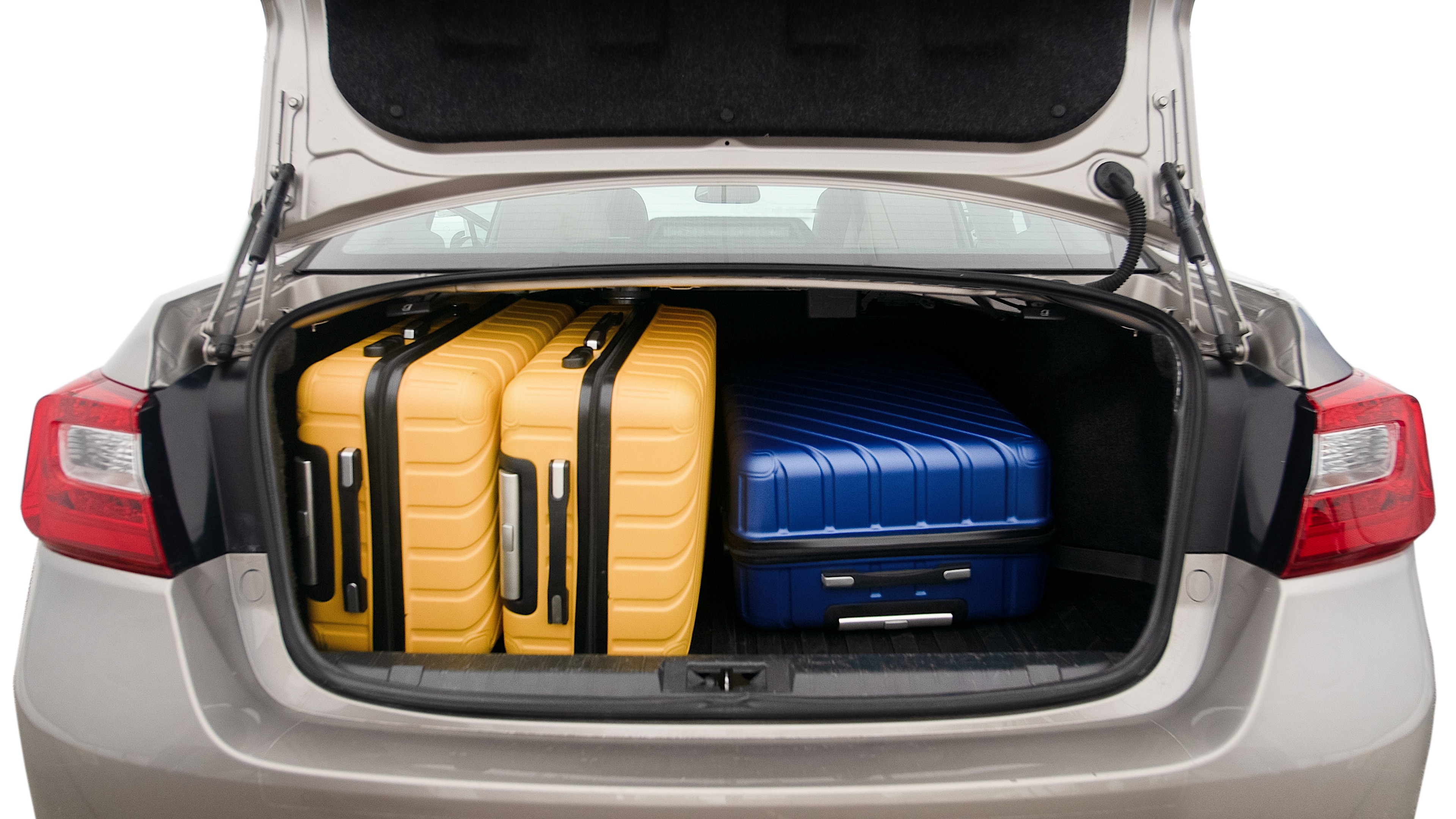The trunk lid is open, showing full view of the trunk space. One extra large suitcase, two large suitcases and one small suitcase are placed inside.