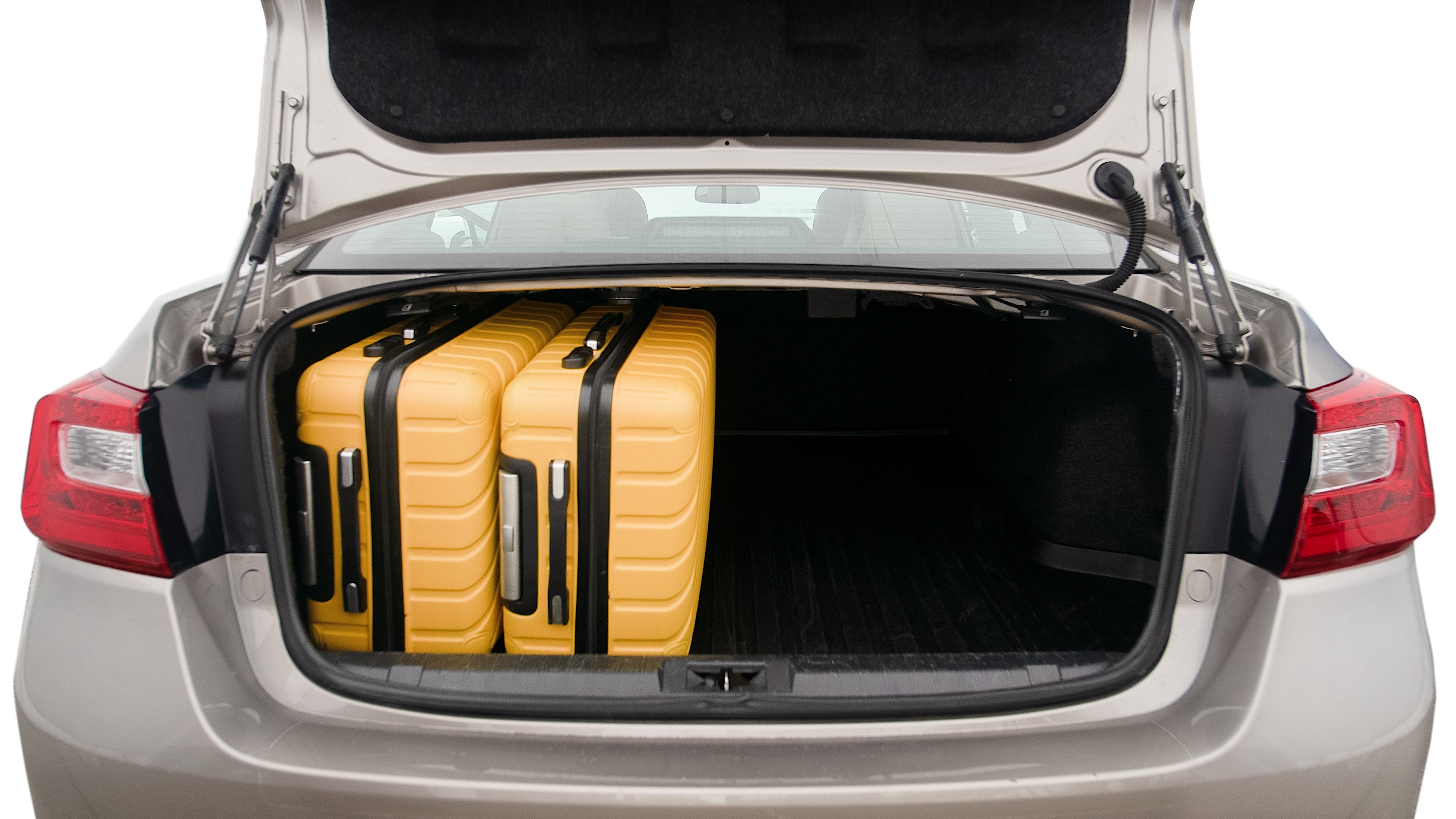 The trunk lid is open, showing full view of the trunk space. One extra large suitcase, two large suitcases and one small suitcase are placed inside.
