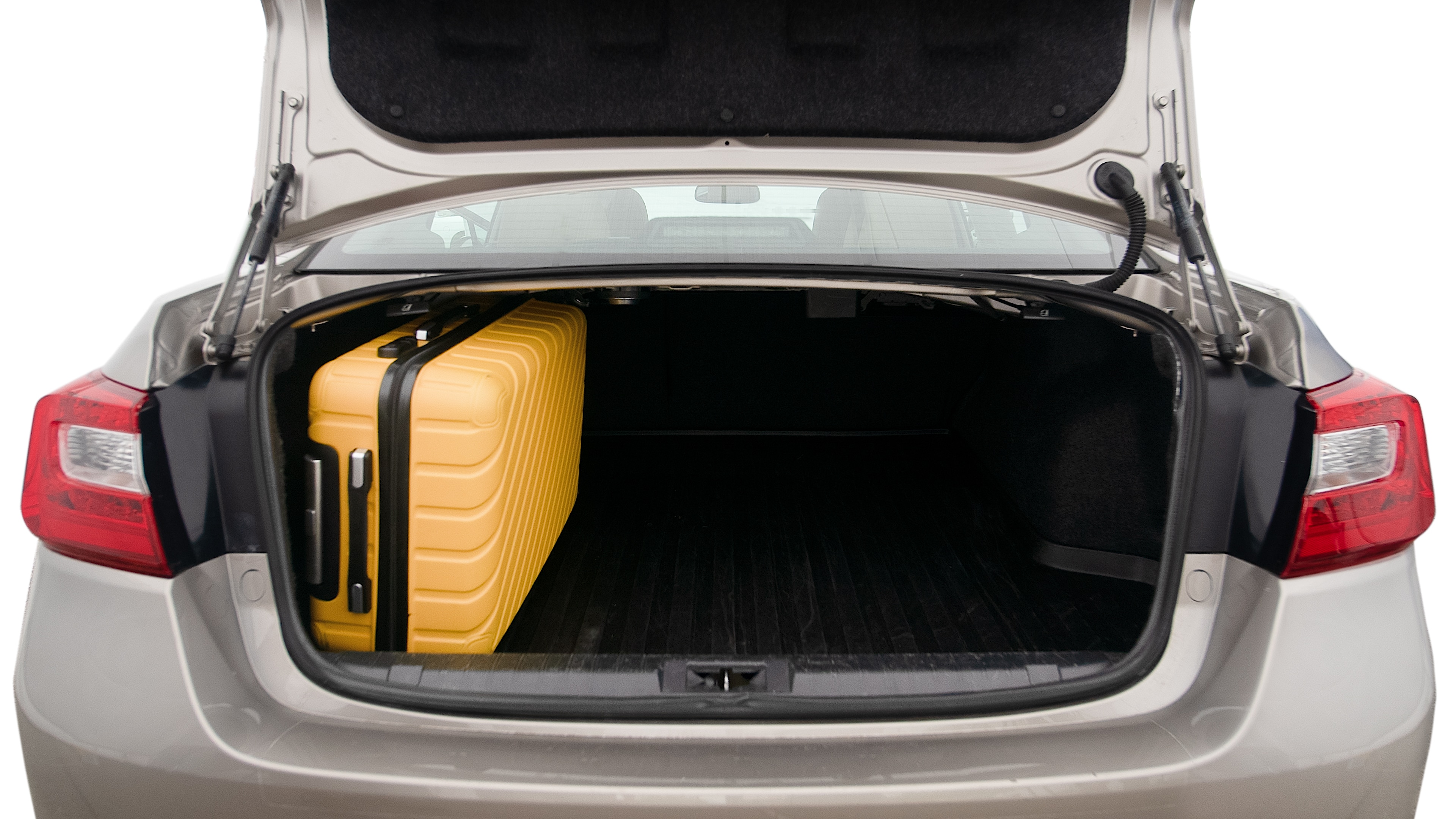 The trunk lid is open, showing full view of the trunk space. One extra large suitcase, two large suitcases and one small suitcase are placed inside.