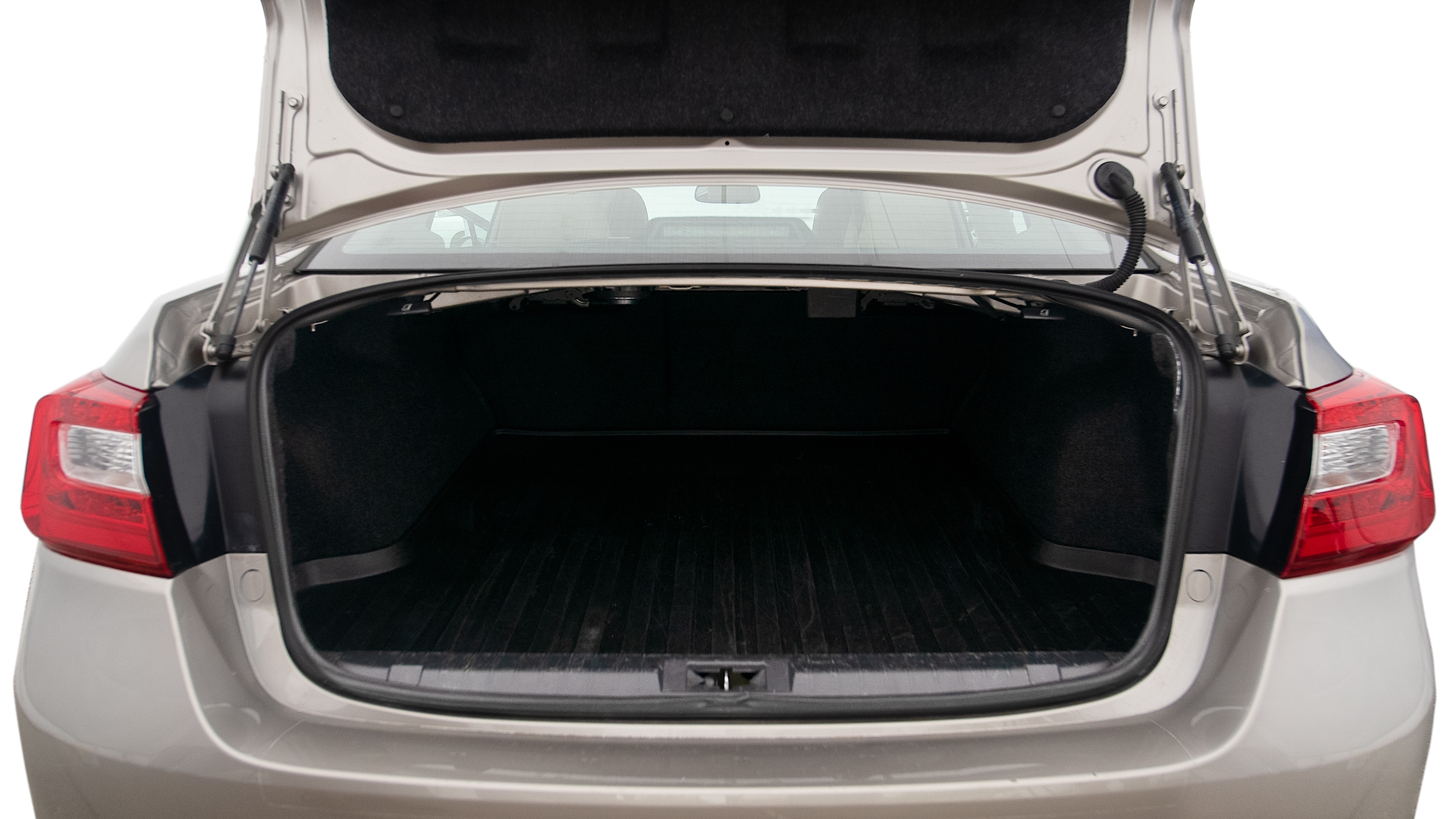 The trunk lid is open, showing full view of the trunk space. One extra large suitcase, two large suitcases and one small suitcase are placed inside.