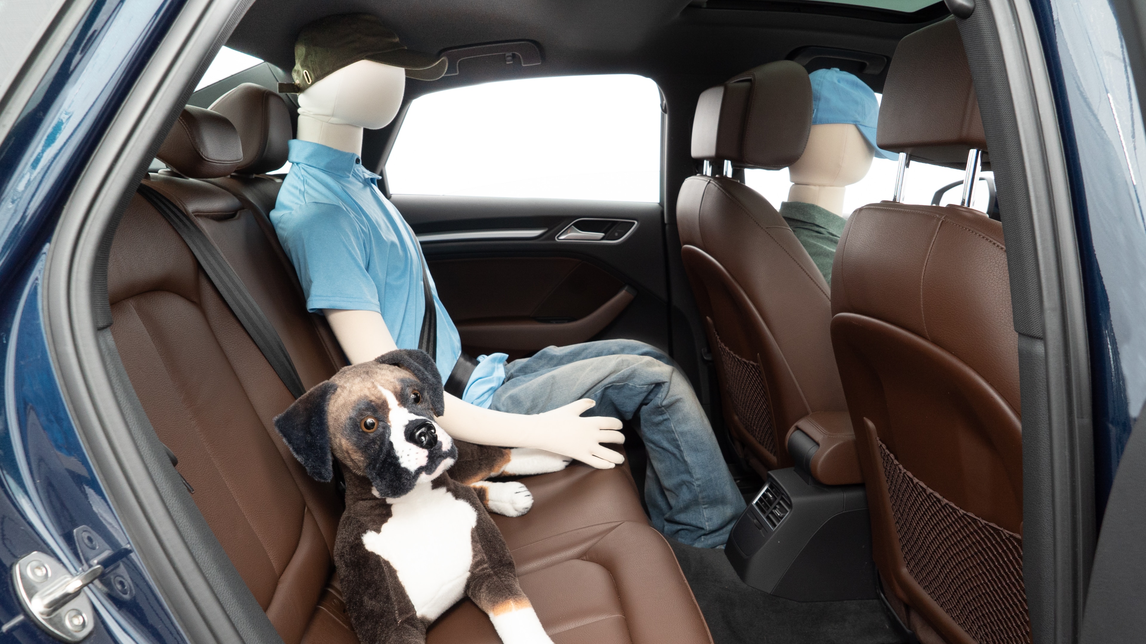 A series of second-row backseat photos is shown including one seating a baby seat and one seating a 6'1" mannequin.