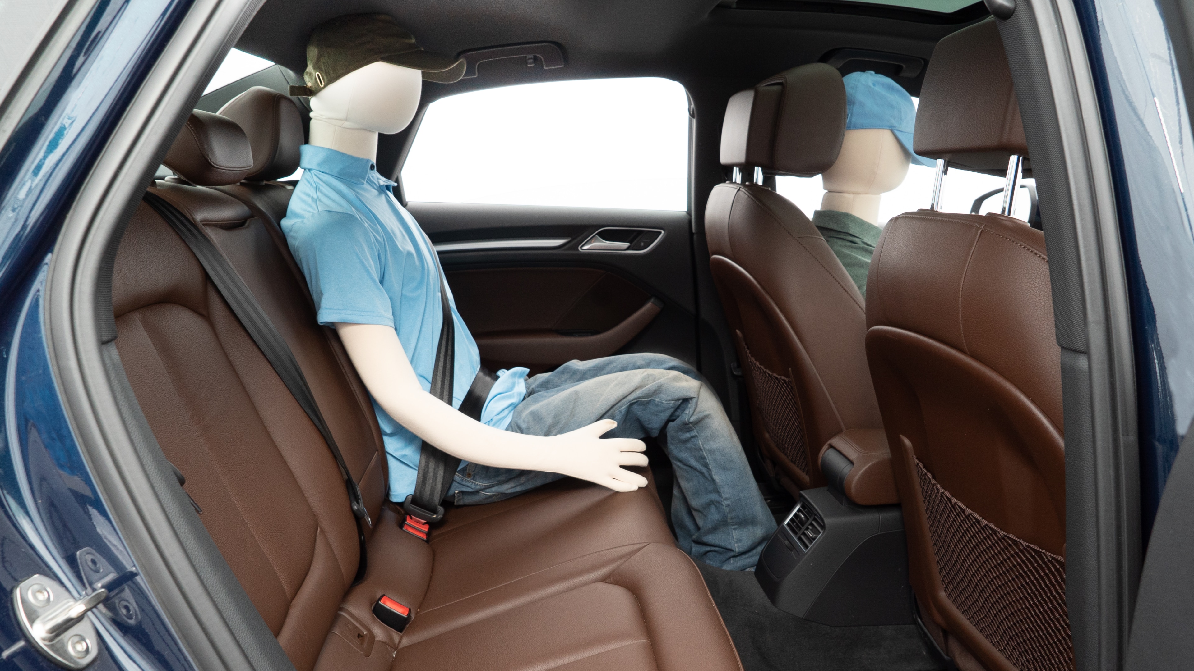 A series of second-row backseat photos is shown including one seating a baby seat and one seating a 6'1" mannequin.