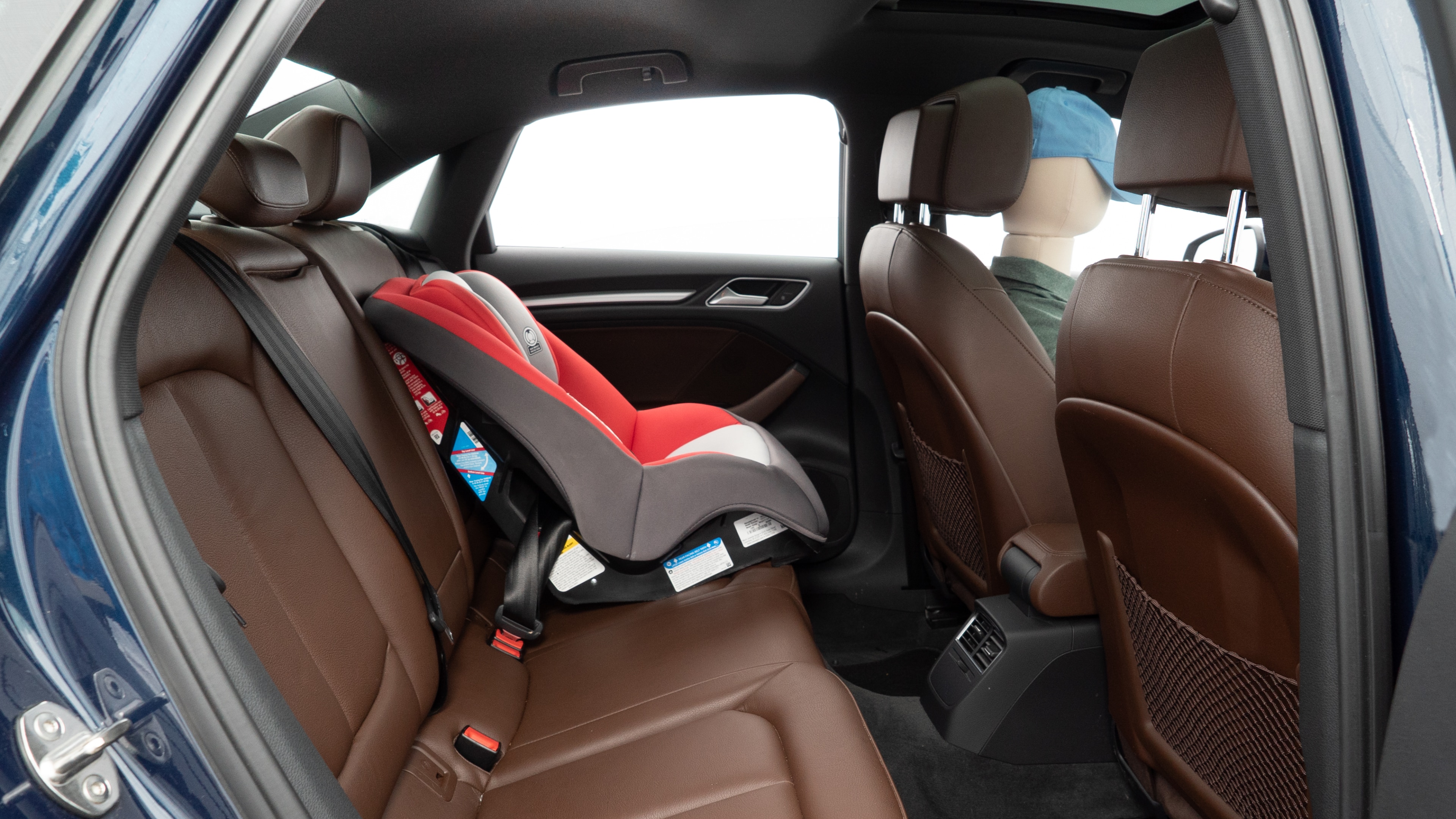 A series of second-row backseat photos is shown including one seating a baby seat and one seating a 6'1" mannequin.