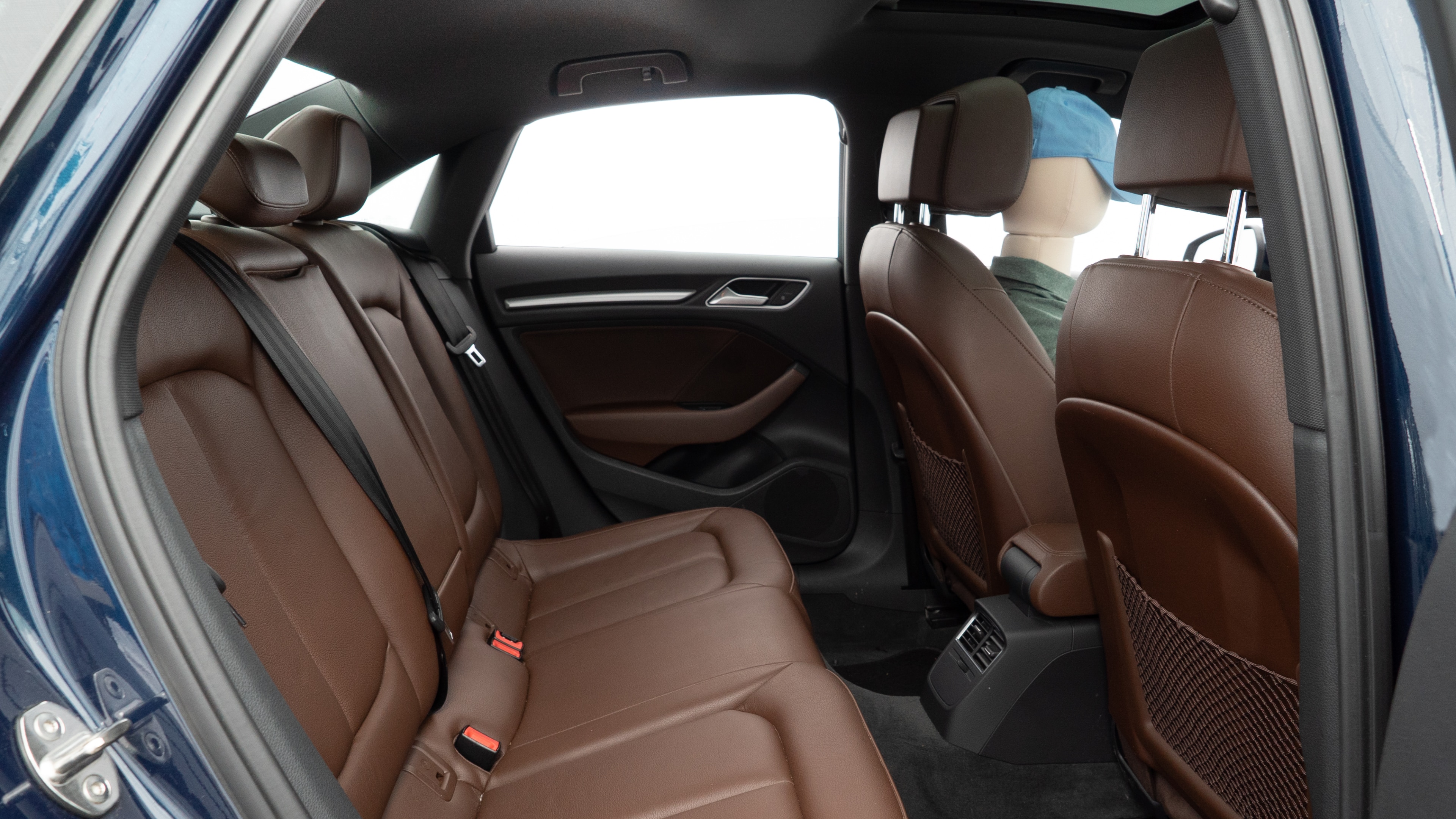 A series of second-row backseat photos is shown including one seating a baby seat and one seating a 6'1" mannequin.