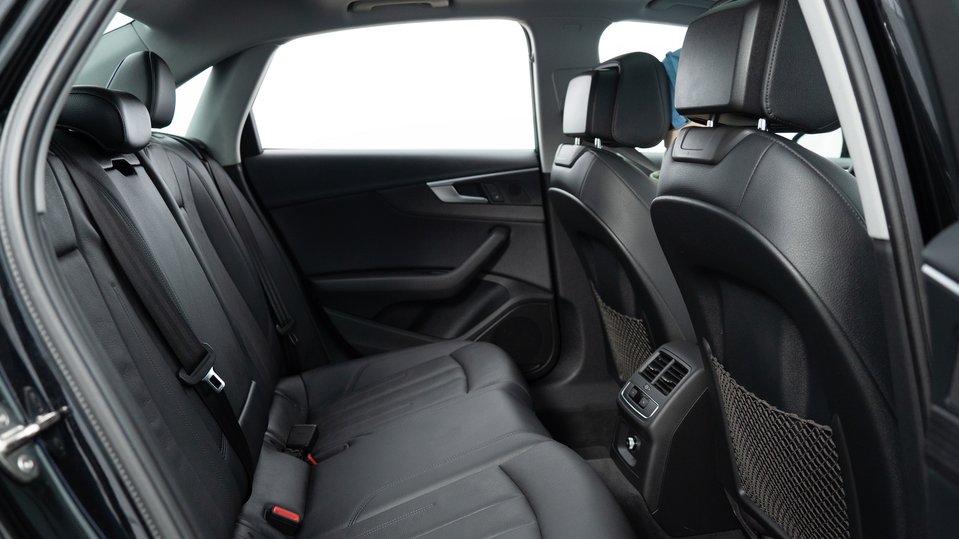 A series of second-row backseat photos is shown including one seating a baby seat, a dog and one seating a 6'1" mannequin.
