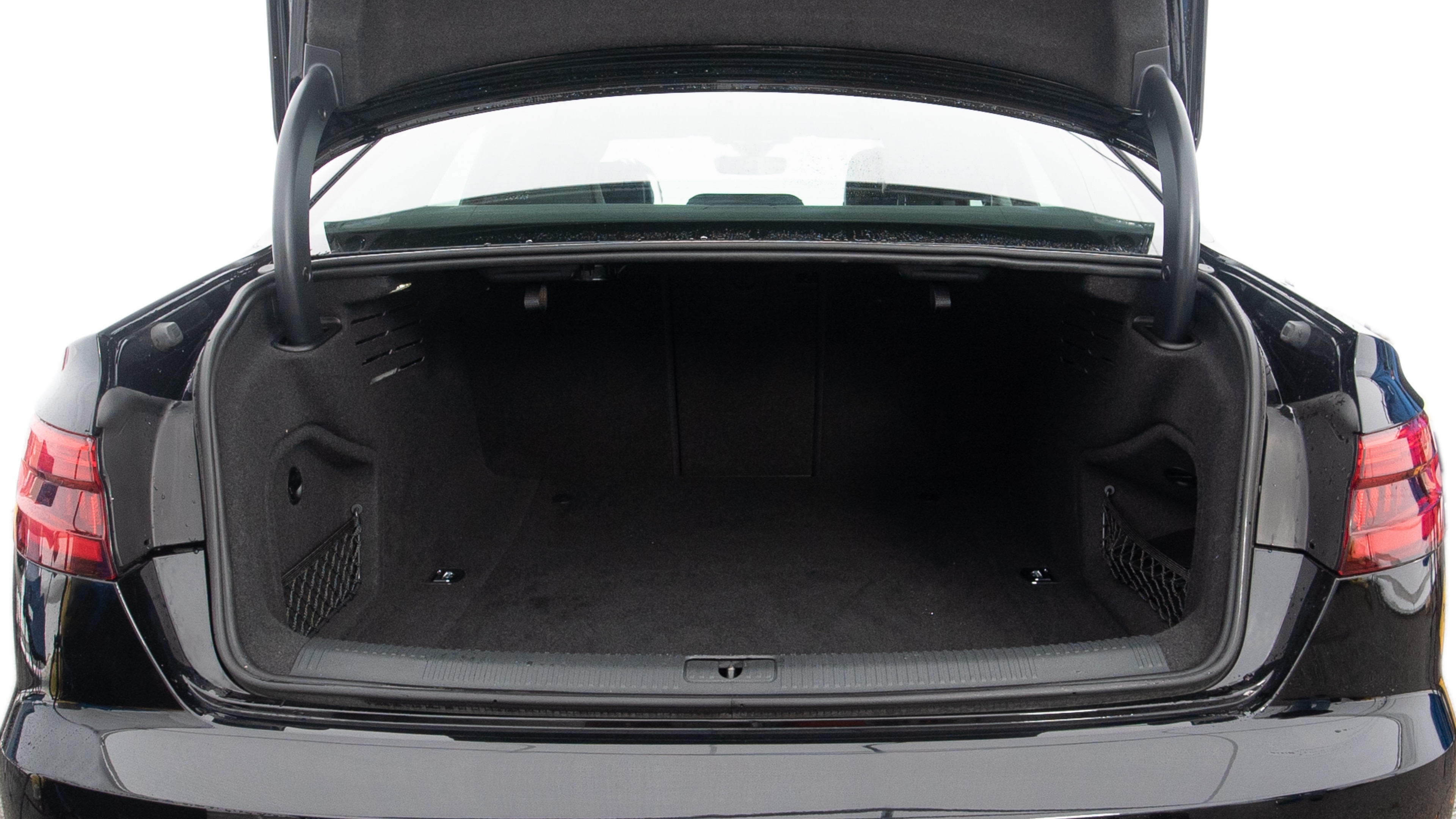 The trunk lid is open showing full view of the trunk. A baby stroller, two grocery carriers, one camping chairs in the carrying bag, and a set of golf clubs are placed inside.