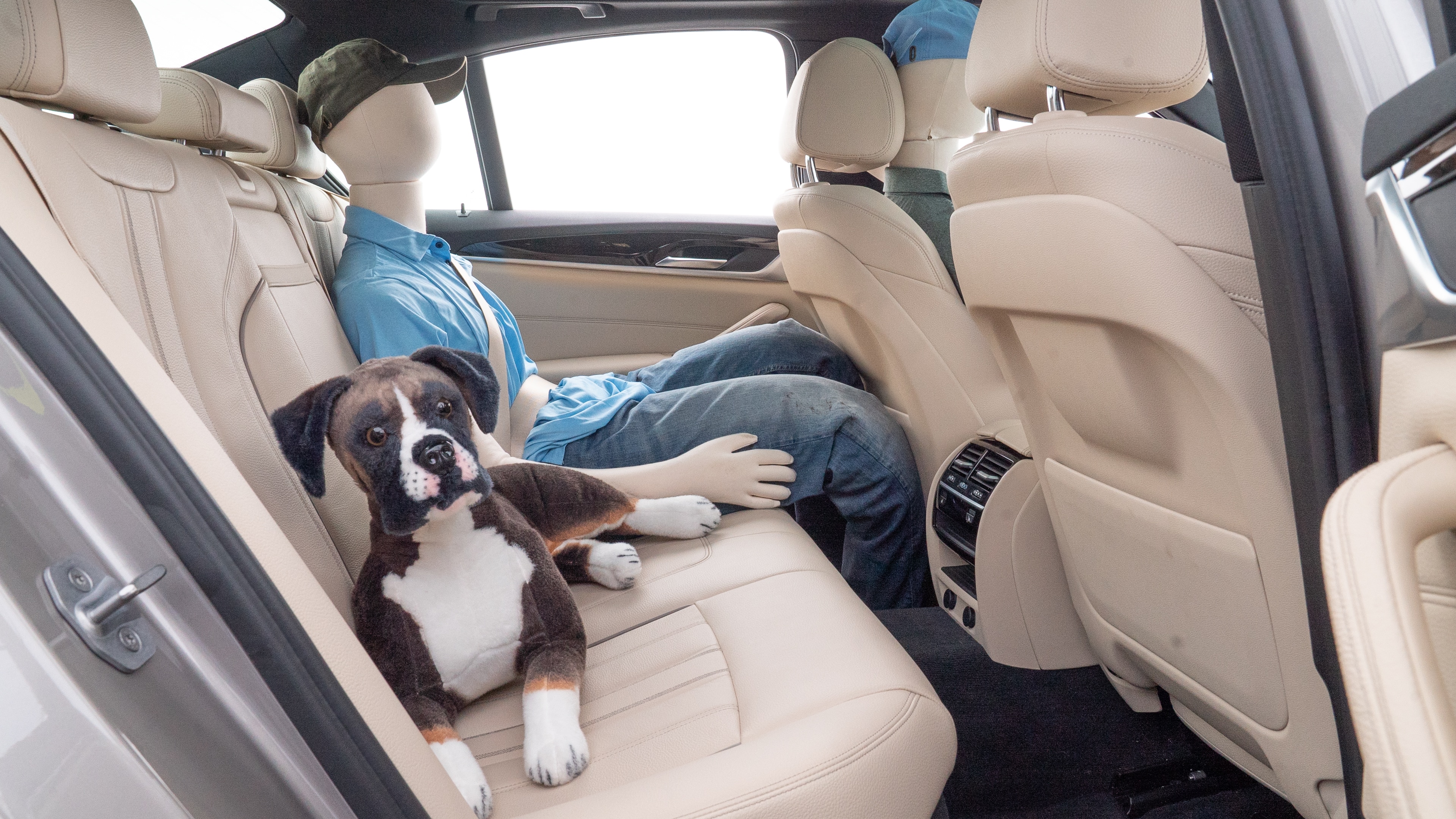 A series of second-row backseat photos is shown including one seating a baby seat and one seating a 6'1" mannequin.