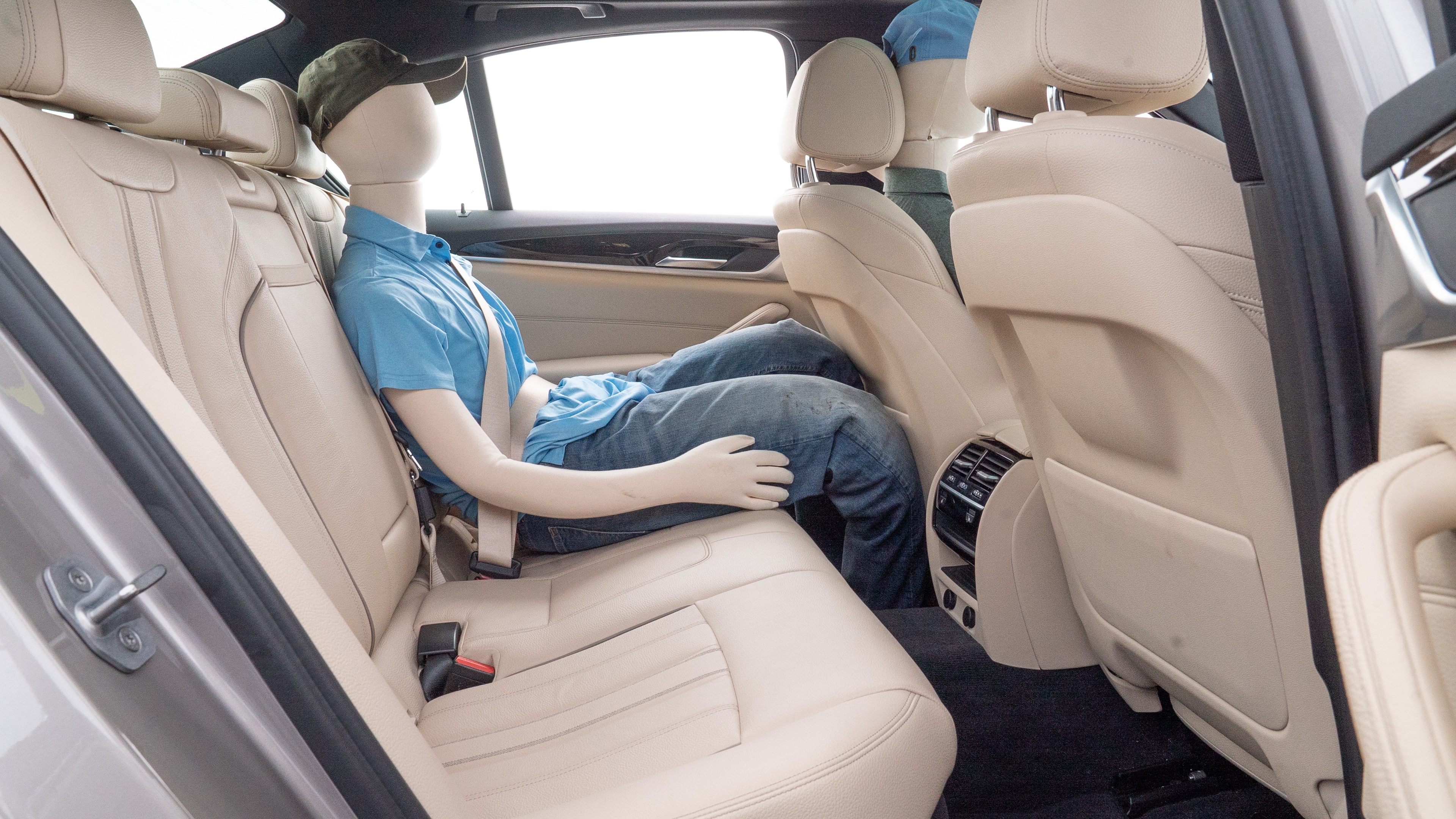 A series of second-row backseat photos is shown including one seating a baby seat and one seating a 6'1" mannequin.