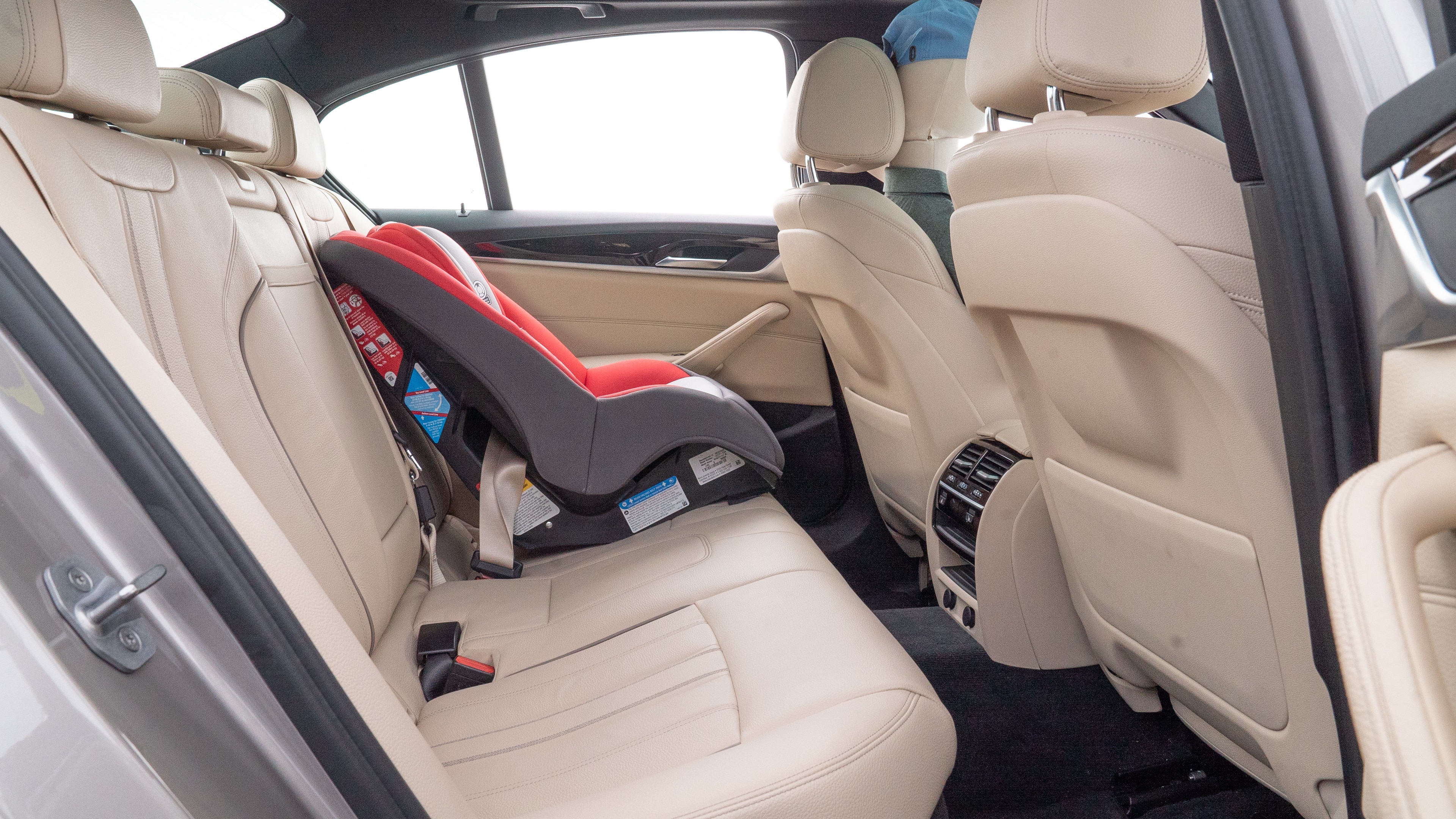A series of second-row backseat photos is shown including one seating a baby seat and one seating a 6'1" mannequin.