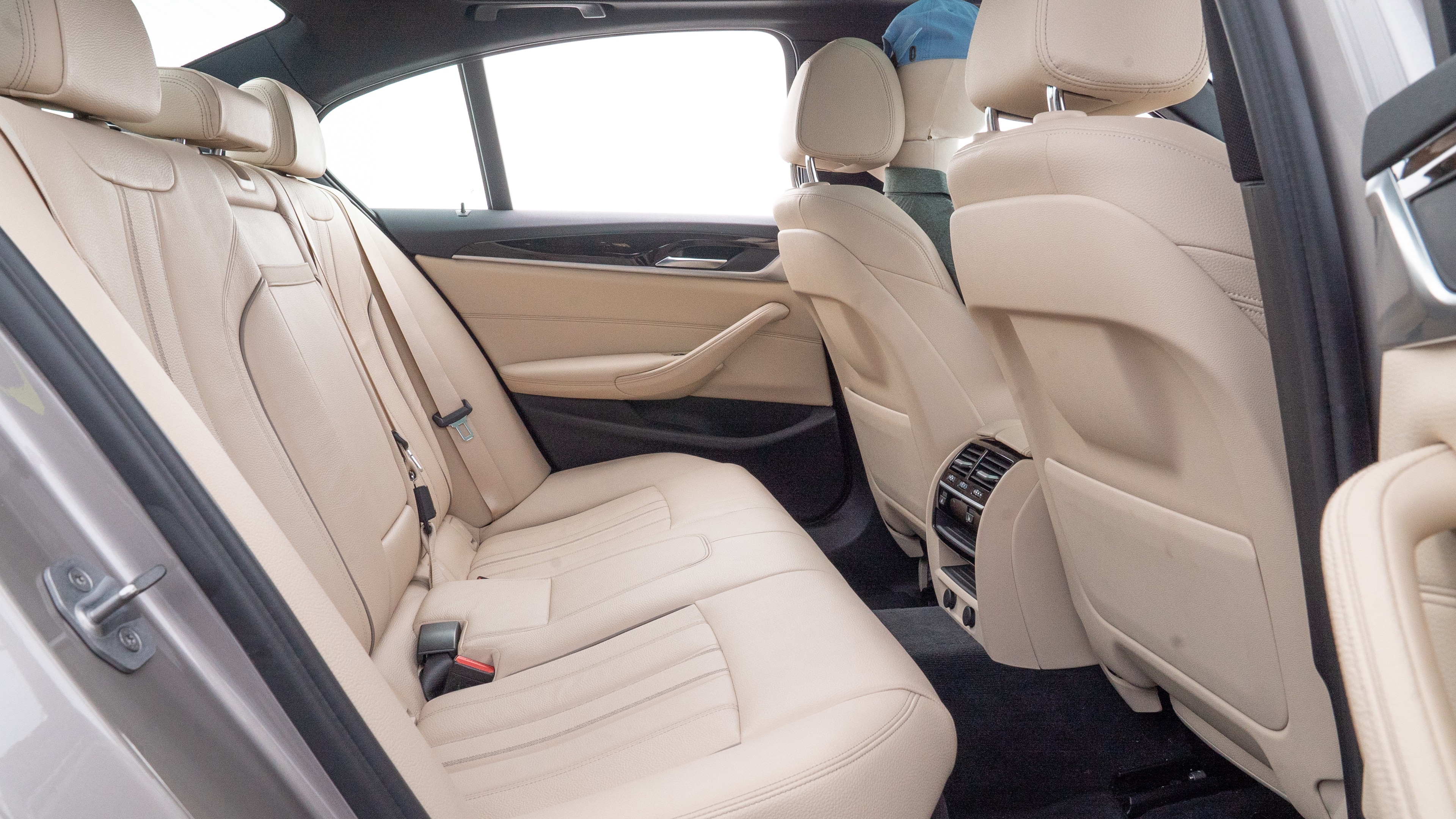 A series of second-row backseat photos is shown including one seating a baby seat and one seating a 6'1" mannequin.
