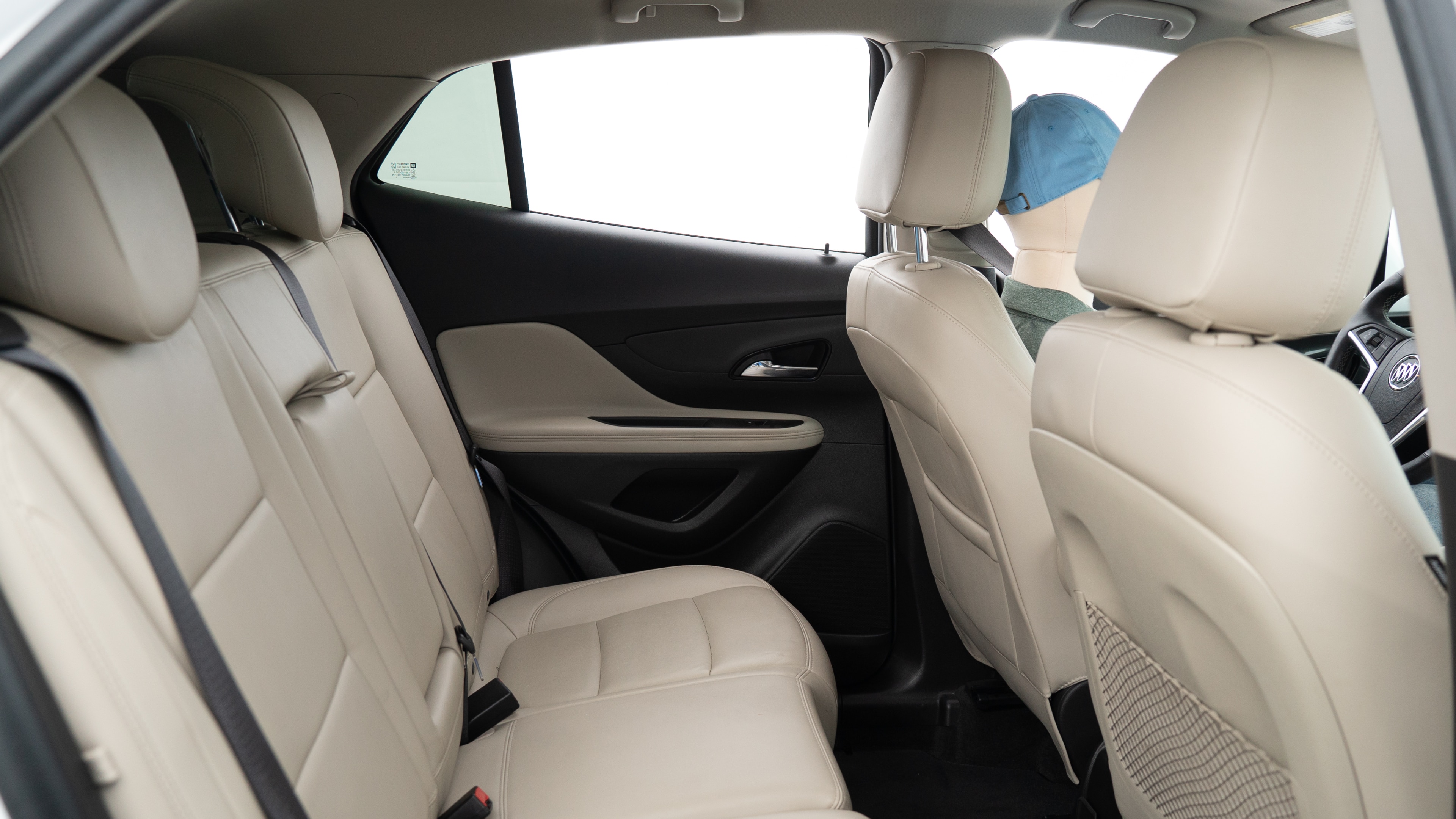 A series of second-row backseat photos is shown including one seating a baby seat, a dog and one seating a 6'1" mannequin.