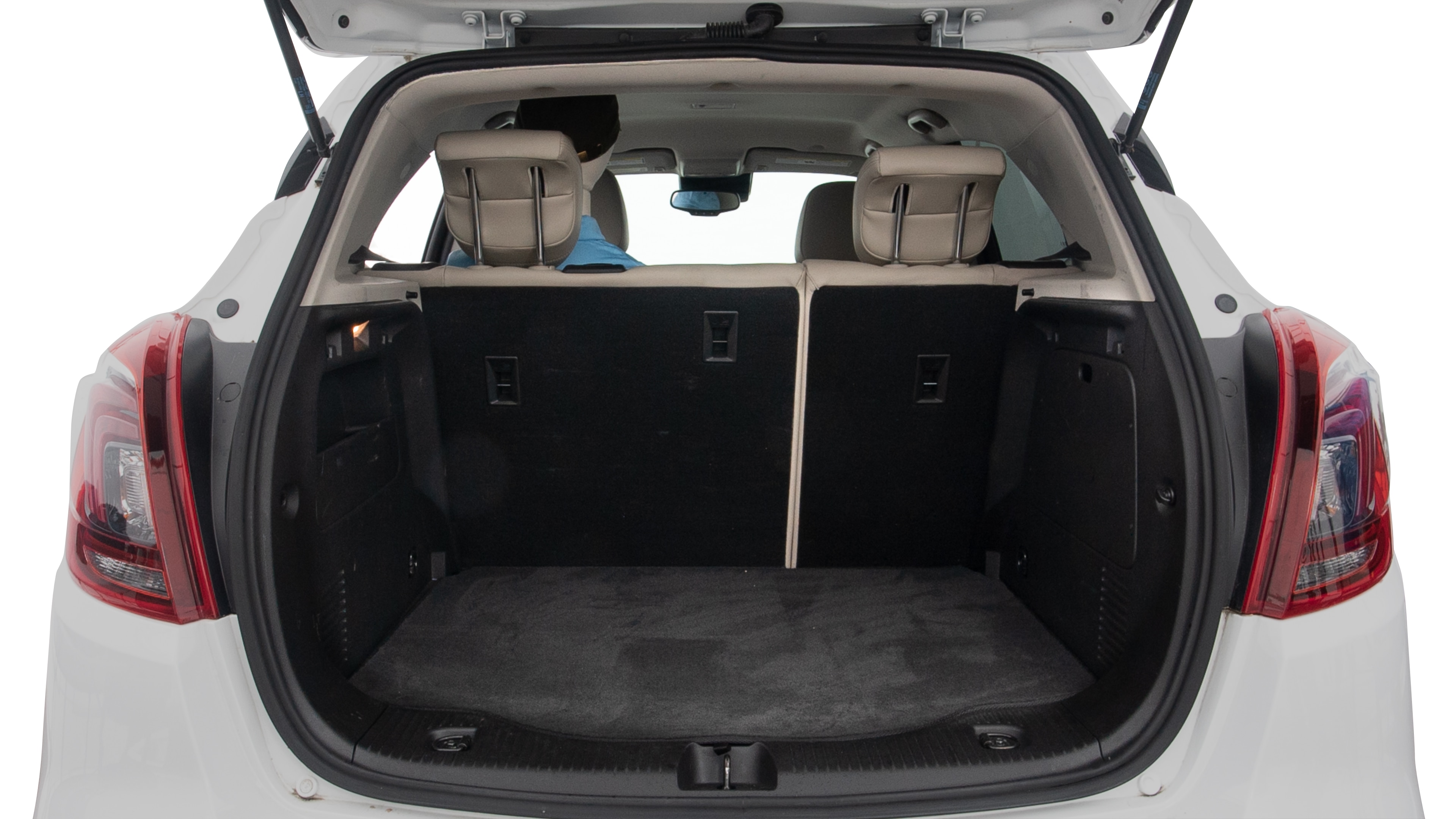 The trunk lid is open showing full view of the trunk. A baby stroller and three grocery carriers are placed inside.