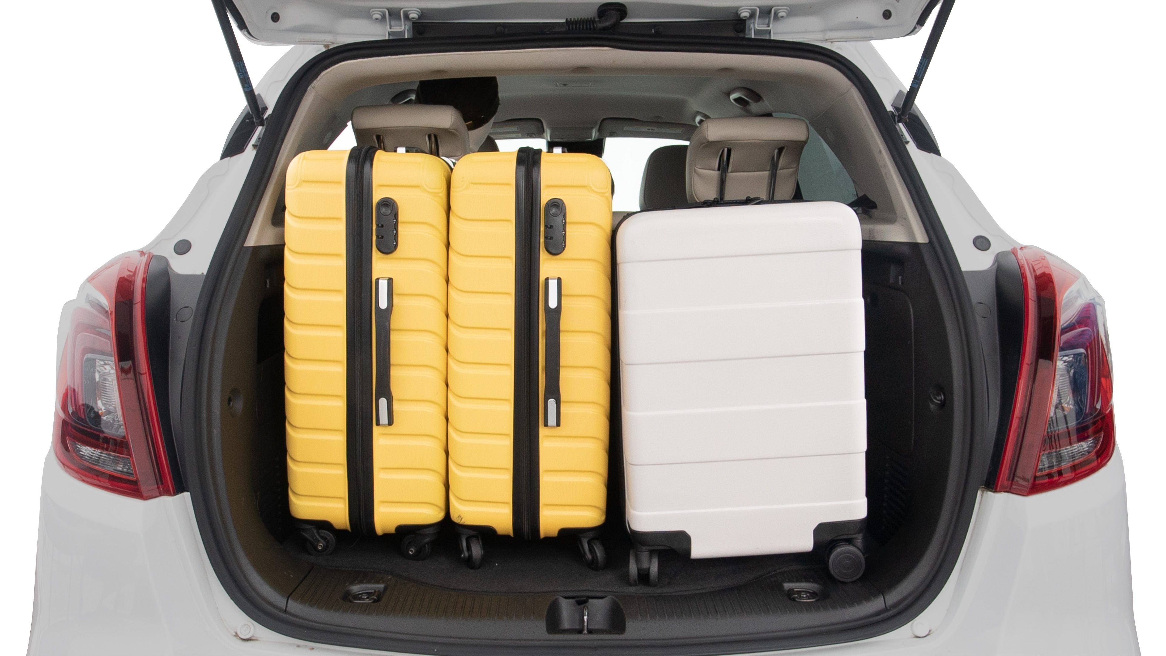 The trunk lid is open, showing full view of the trunk space. Two large and two small suitcases are placed inside.