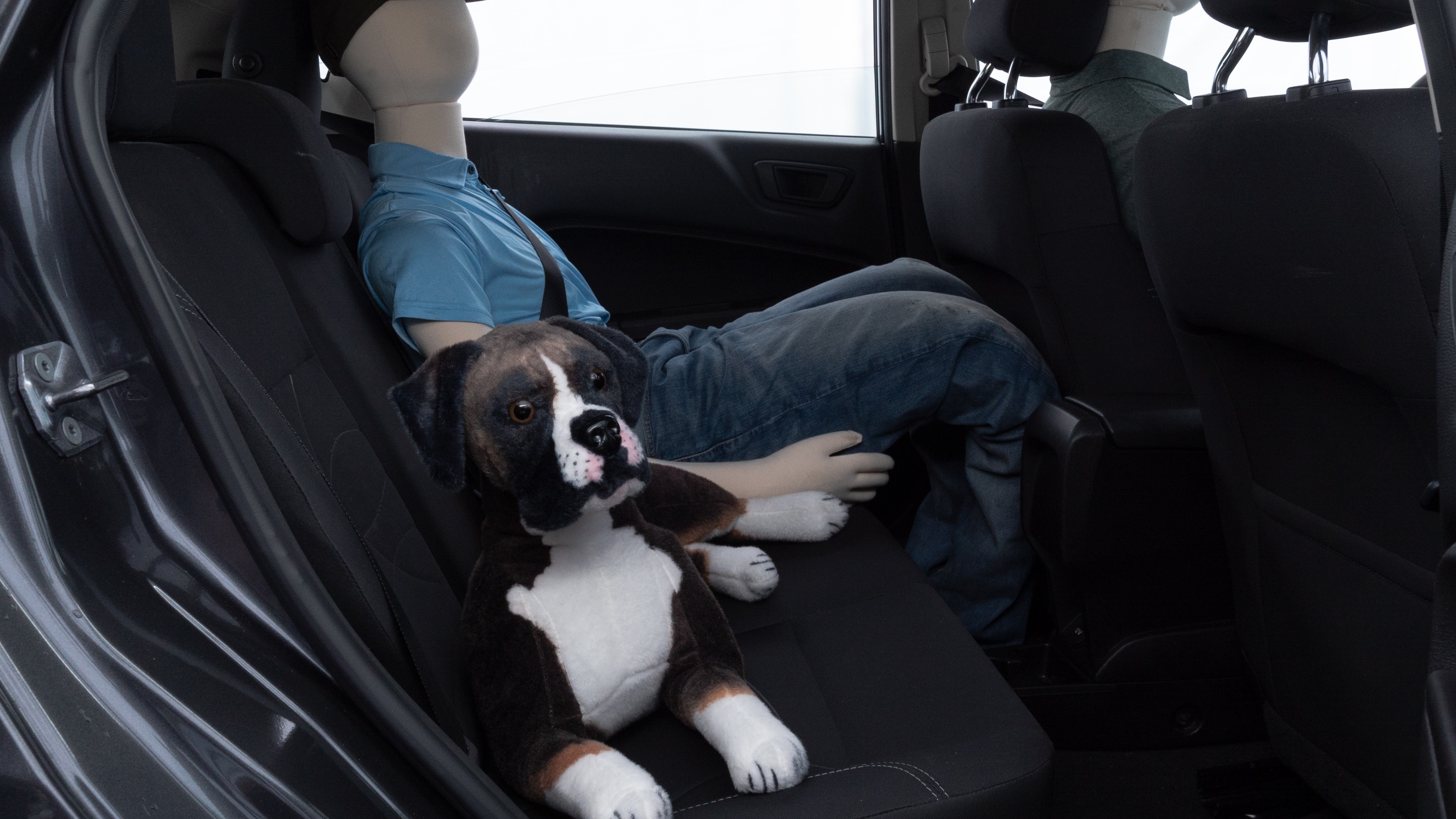 A series of second-row backseat photos is shown including one seating a baby seat and one seating a 6'1" mannequin.