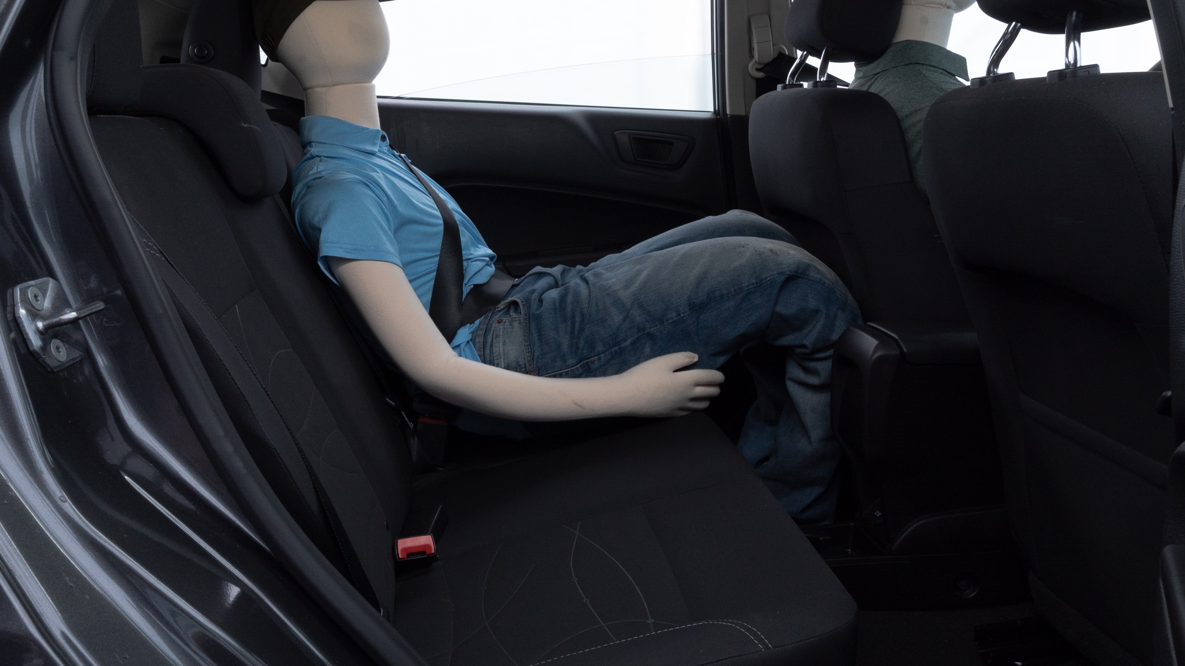 A series of second-row backseat photos is shown including one seating a baby seat and one seating a 6'1" mannequin.
