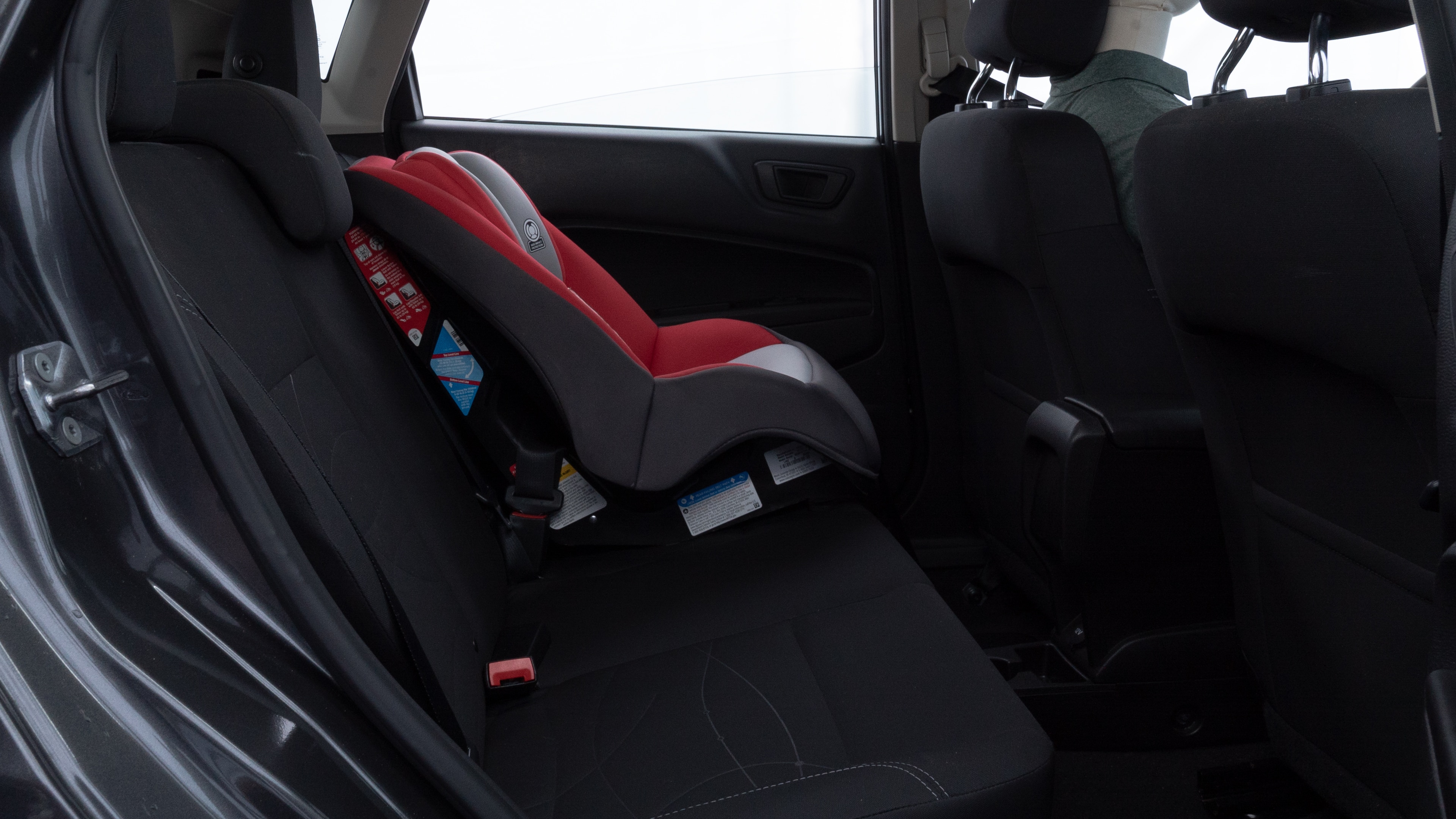 A series of second-row backseat photos is shown including one seating a baby seat and one seating a 6'1" mannequin.