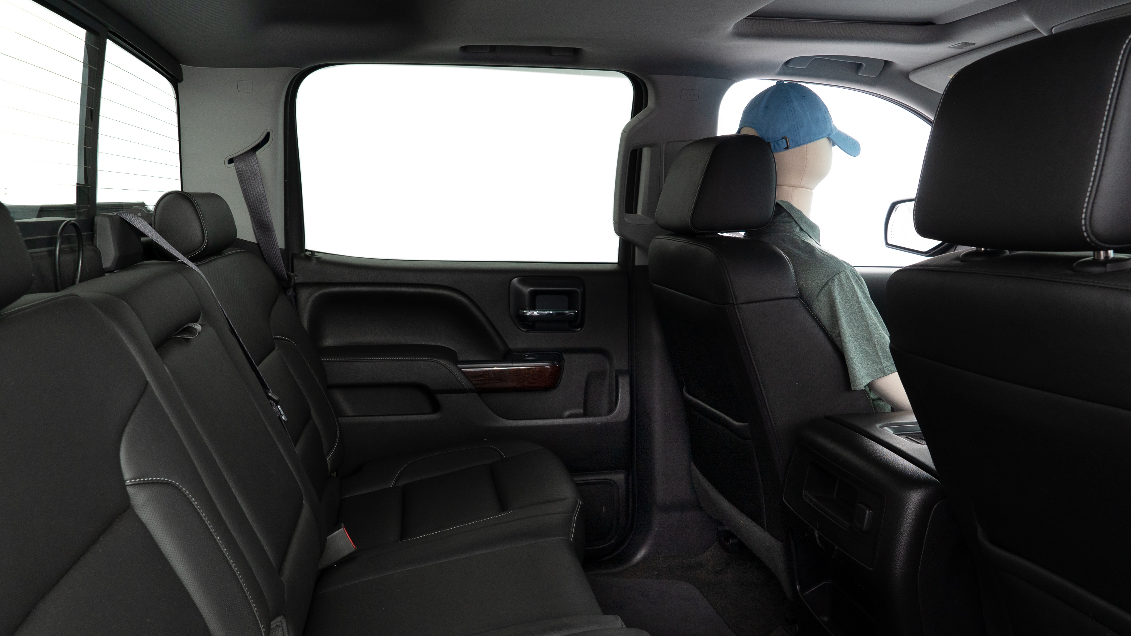 A series of second-row backseat photos is shown including one seating a baby seat and one seating a 6'1" mannequin.