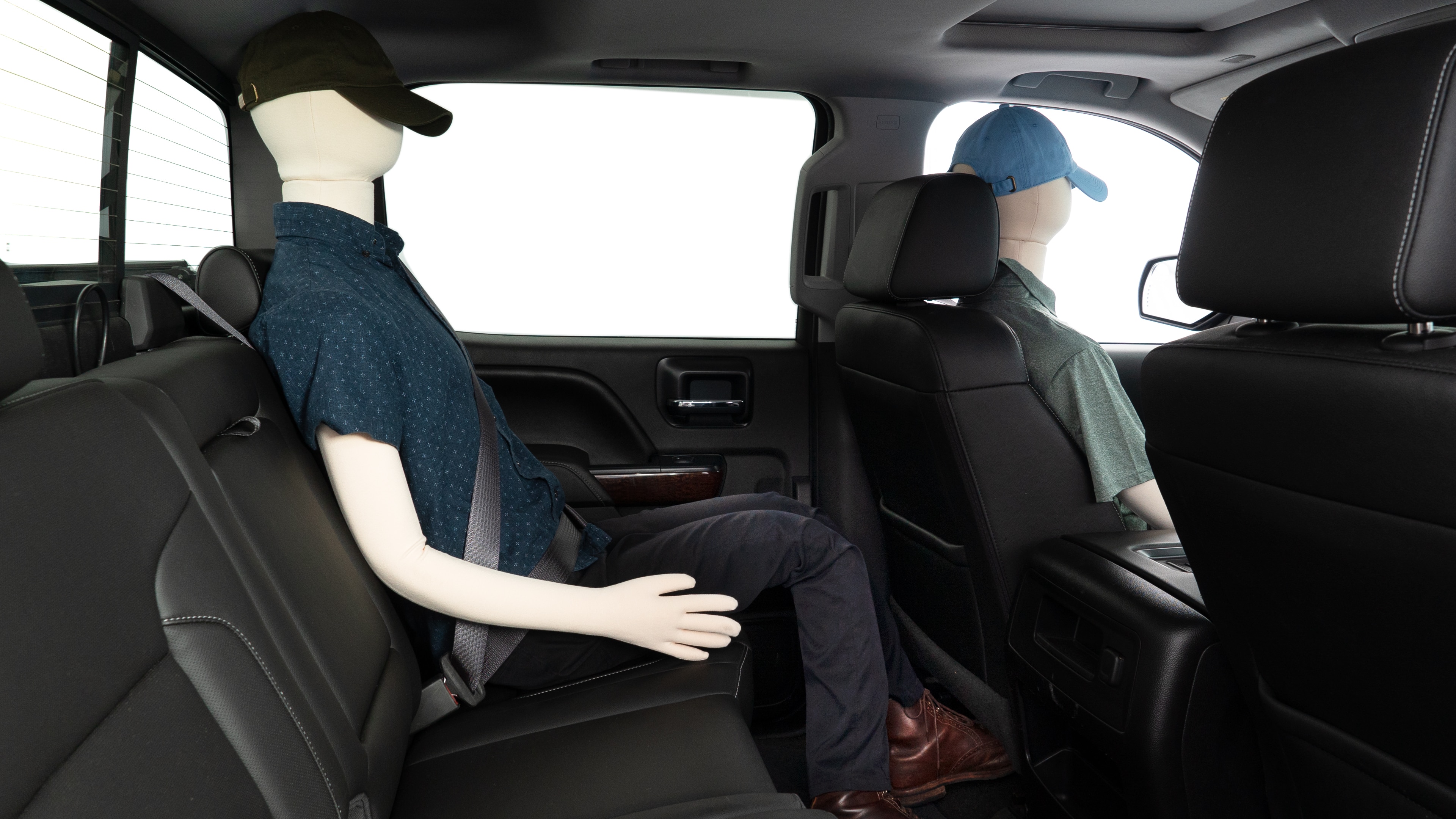 A series of second-row backseat photos is shown including one seating a baby seat and one seating a 6'1" mannequin.