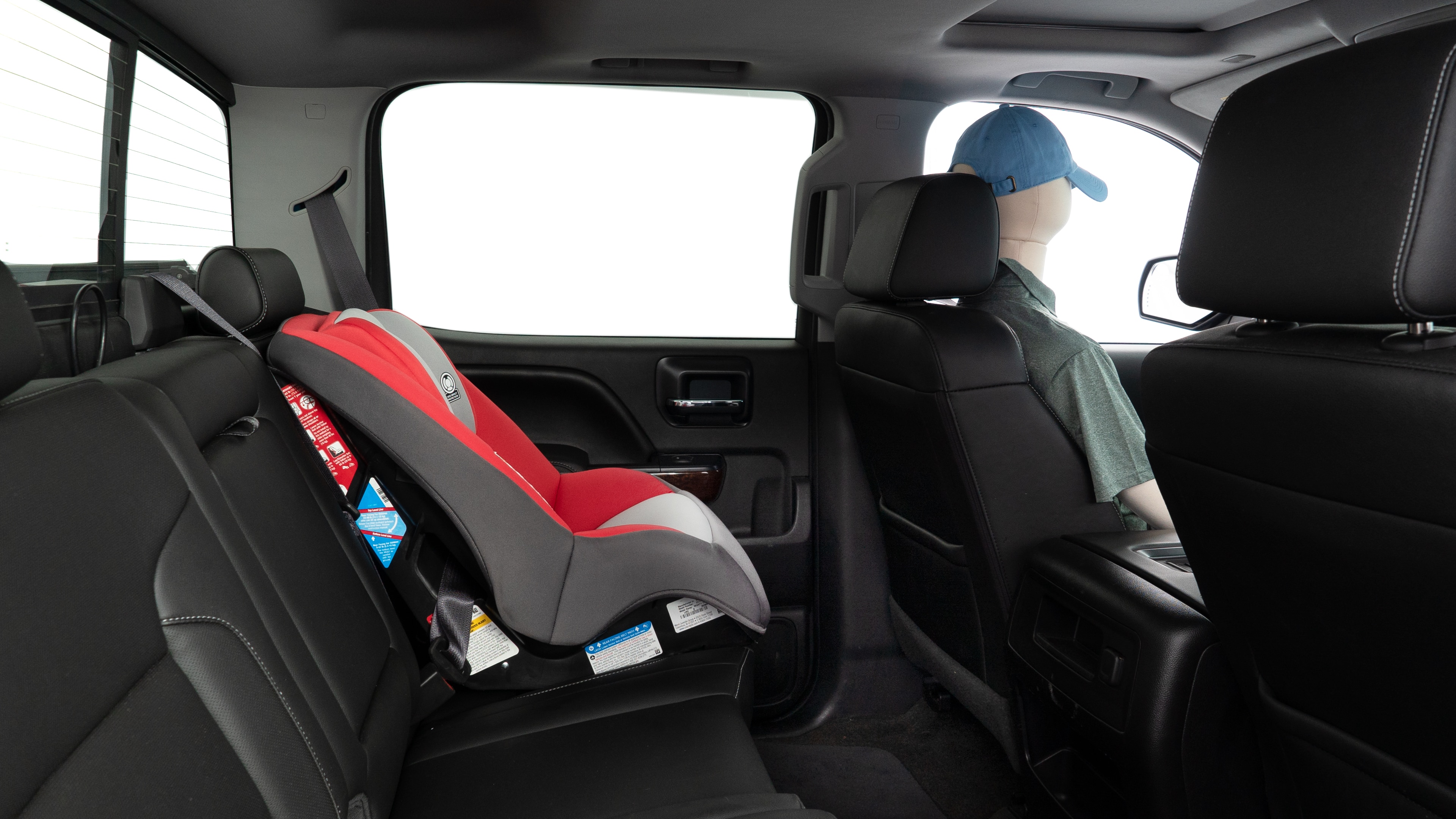 A series of second-row backseat photos is shown including one seating a baby seat and one seating a 6'1" mannequin.