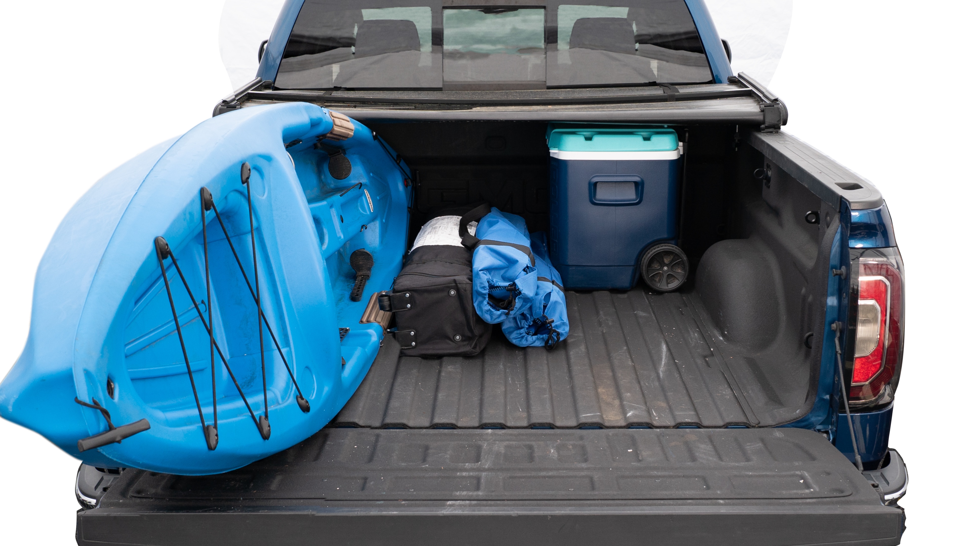 The trunk area is open giving a full view of the trunk area. A cooler, two camping chairs, a tailgate tent and a kayak are placed inside.