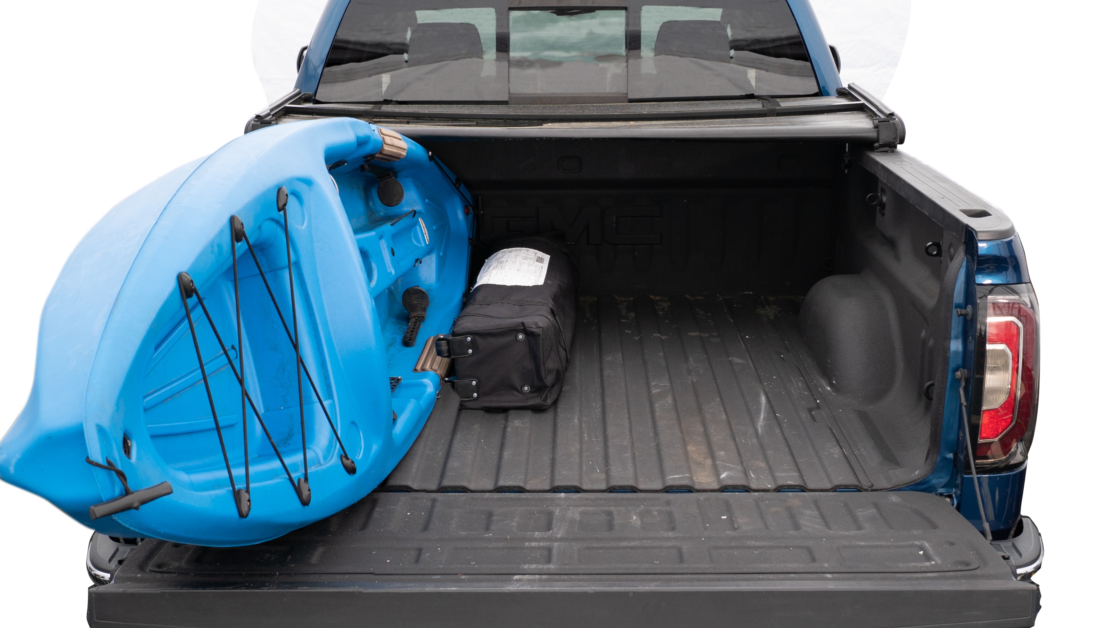 The trunk area is open giving a full view of the trunk area. A cooler, two camping chairs, a tailgate tent and a kayak are placed inside.