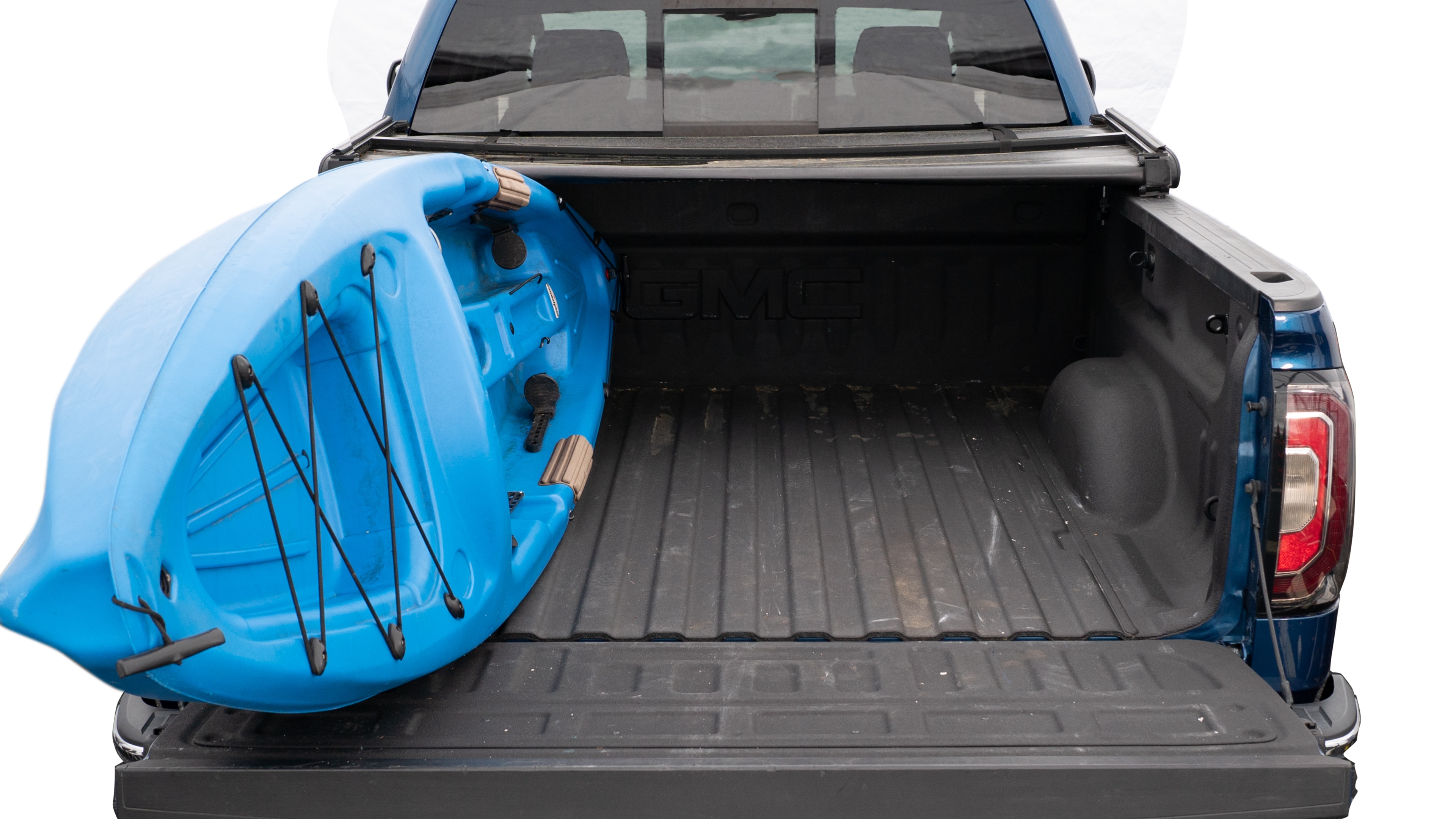The trunk area is open giving a full view of the trunk area. A cooler, two camping chairs, a tailgate tent and a kayak are placed inside.