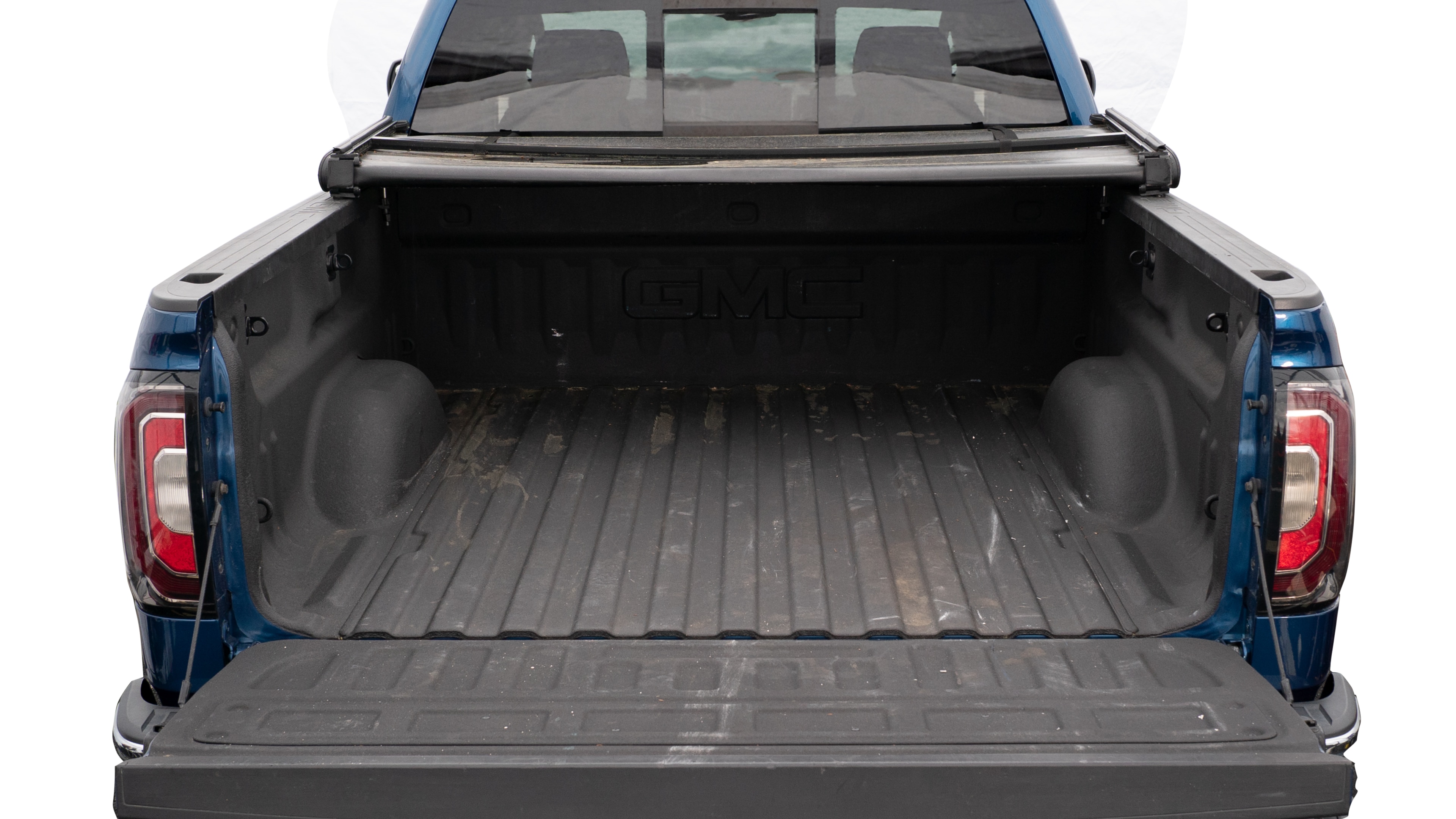 The trunk area is open giving a full view of the trunk area. A cooler, two camping chairs, a tailgate tent and a kayak are placed inside.