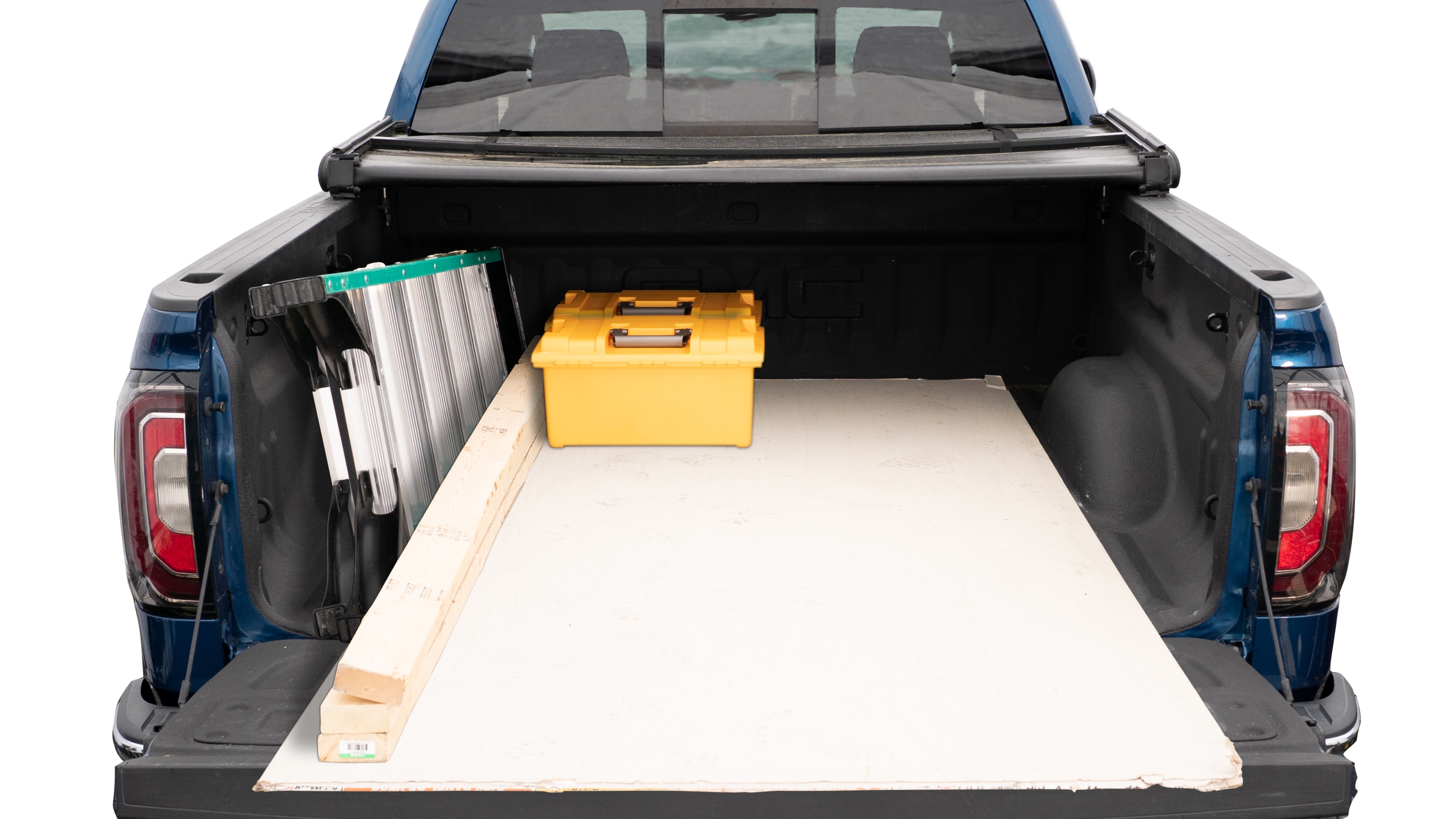 The trunk area is open giving a full view of the trunk area. A ladder, three 2 by 4 framing studs, two toolboxes and a 4 by 8 drywall sheet are placed inside.