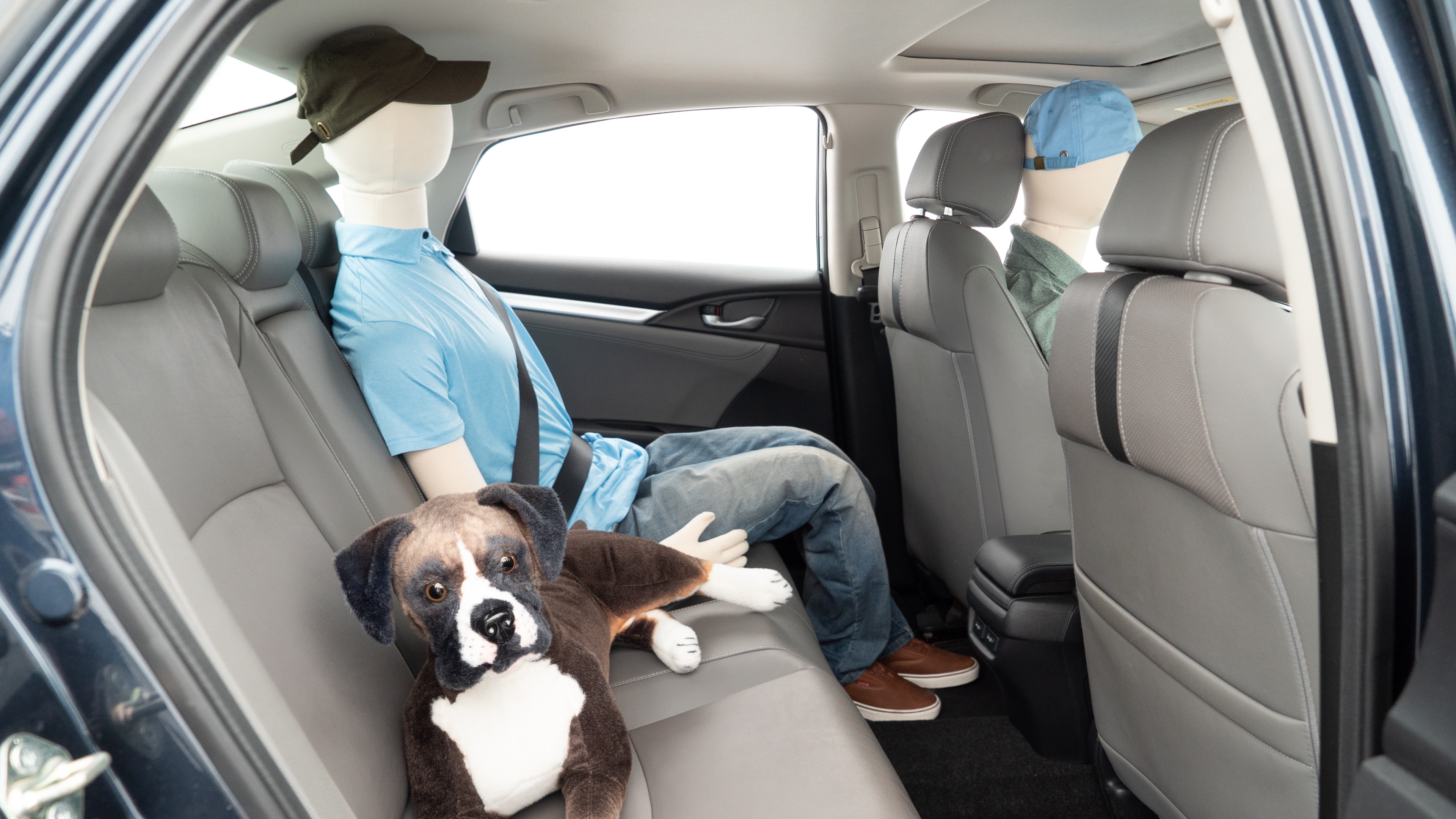 A series of second-row backseat photos is shown including one seating a baby seat and one seating a 6'1" mannequin.
