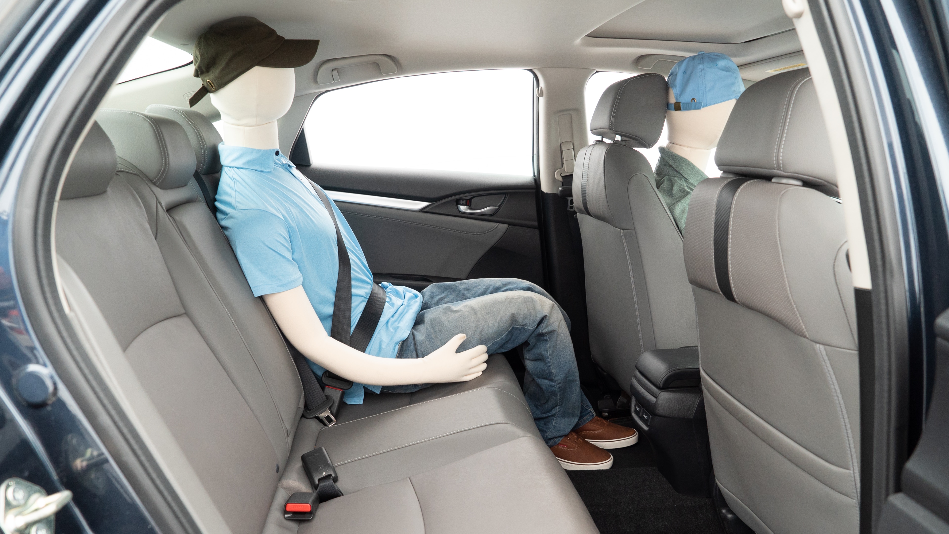 A series of second-row backseat photos is shown including one seating a baby seat and one seating a 6'1" mannequin.