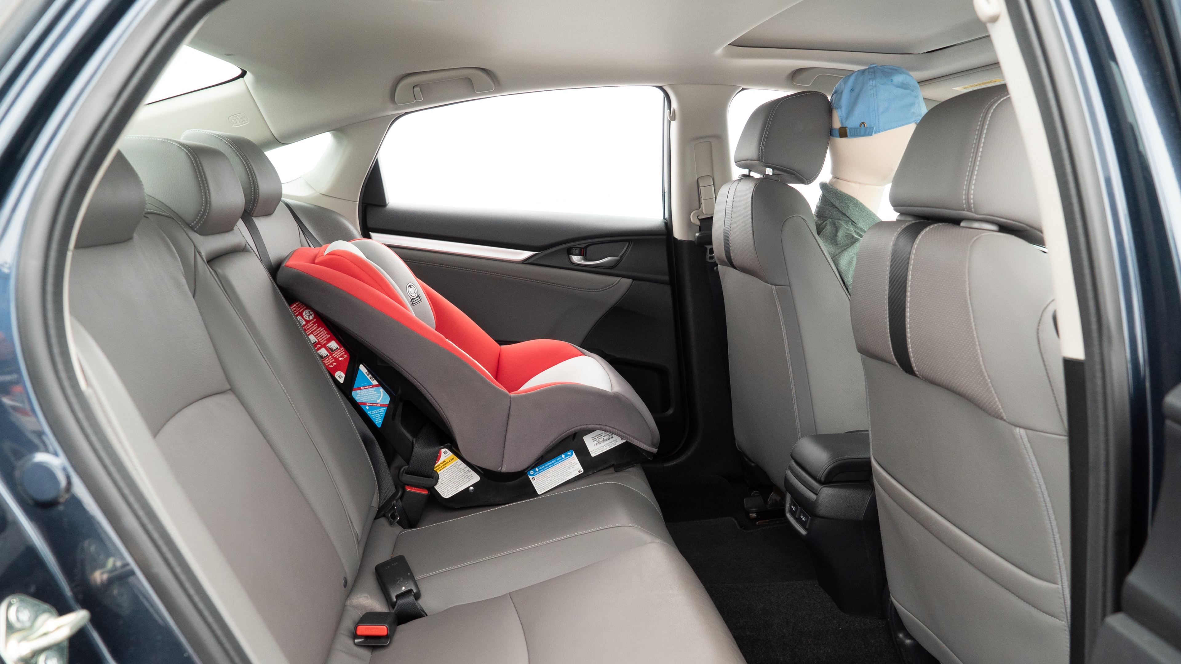 A series of second-row backseat photos is shown including one seating a baby seat and one seating a 6'1" mannequin.