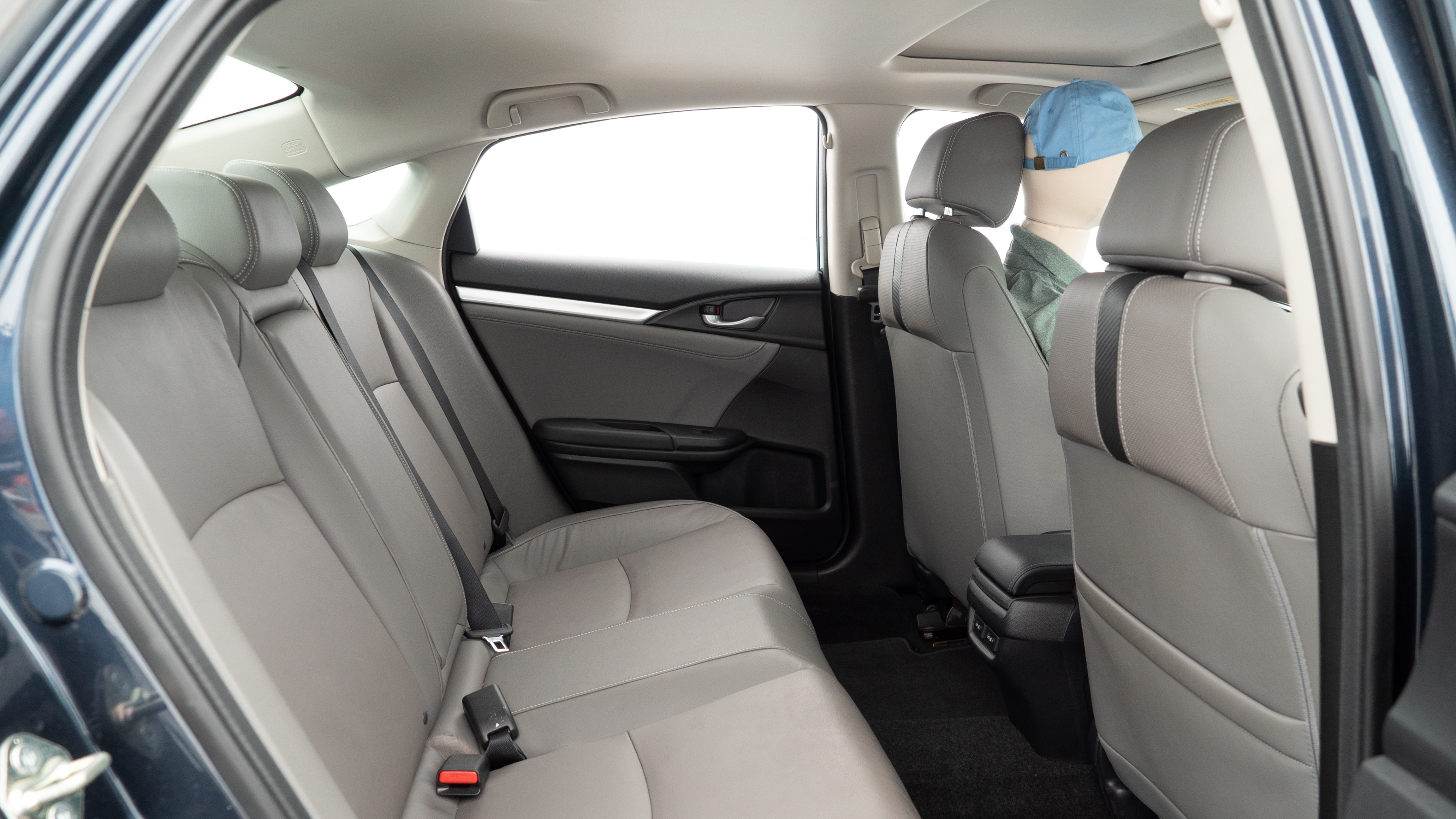 A series of second-row backseat photos is shown including one seating a baby seat and one seating a 6'1" mannequin.