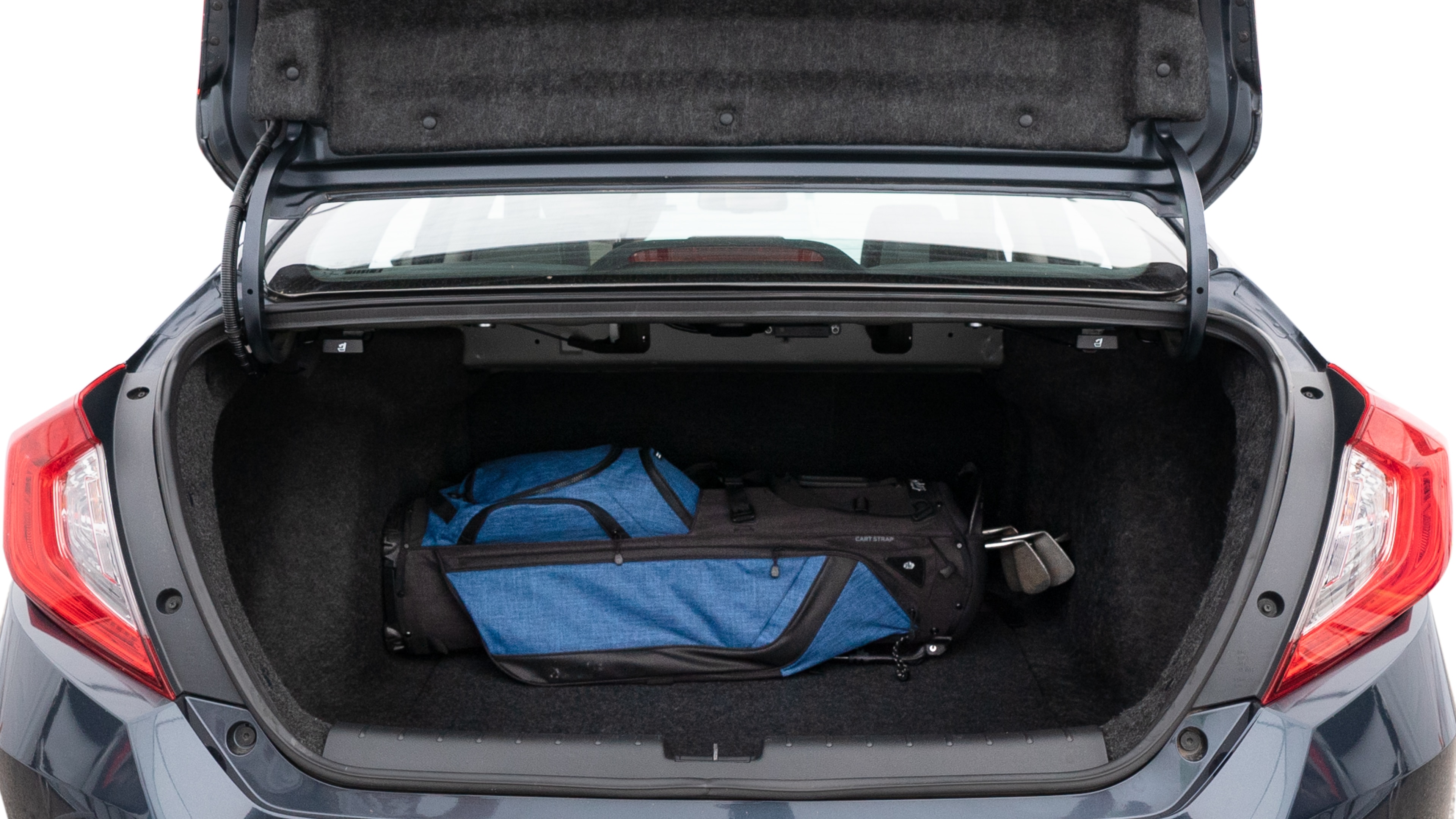 The trunk lid is open showing full view of the trunk. A baby stroller, three grocery carriers, two camping chairs in the carrying bag, and a set of golf clubs are placed inside.