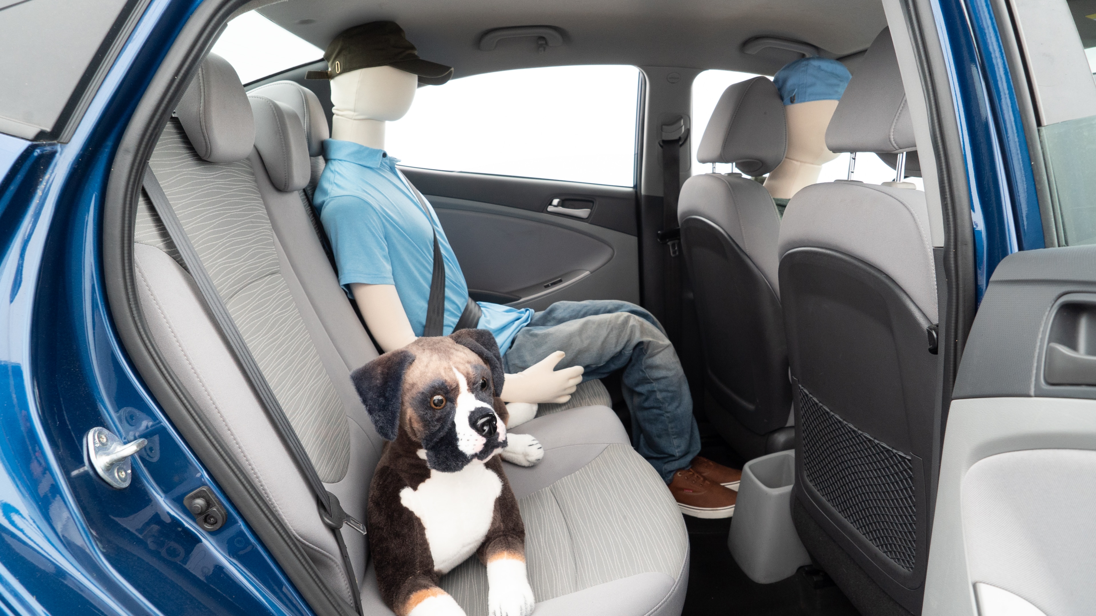 A series of second-row backseat photos is shown including one seating a baby seat and one seating a 6'1" mannequin.
